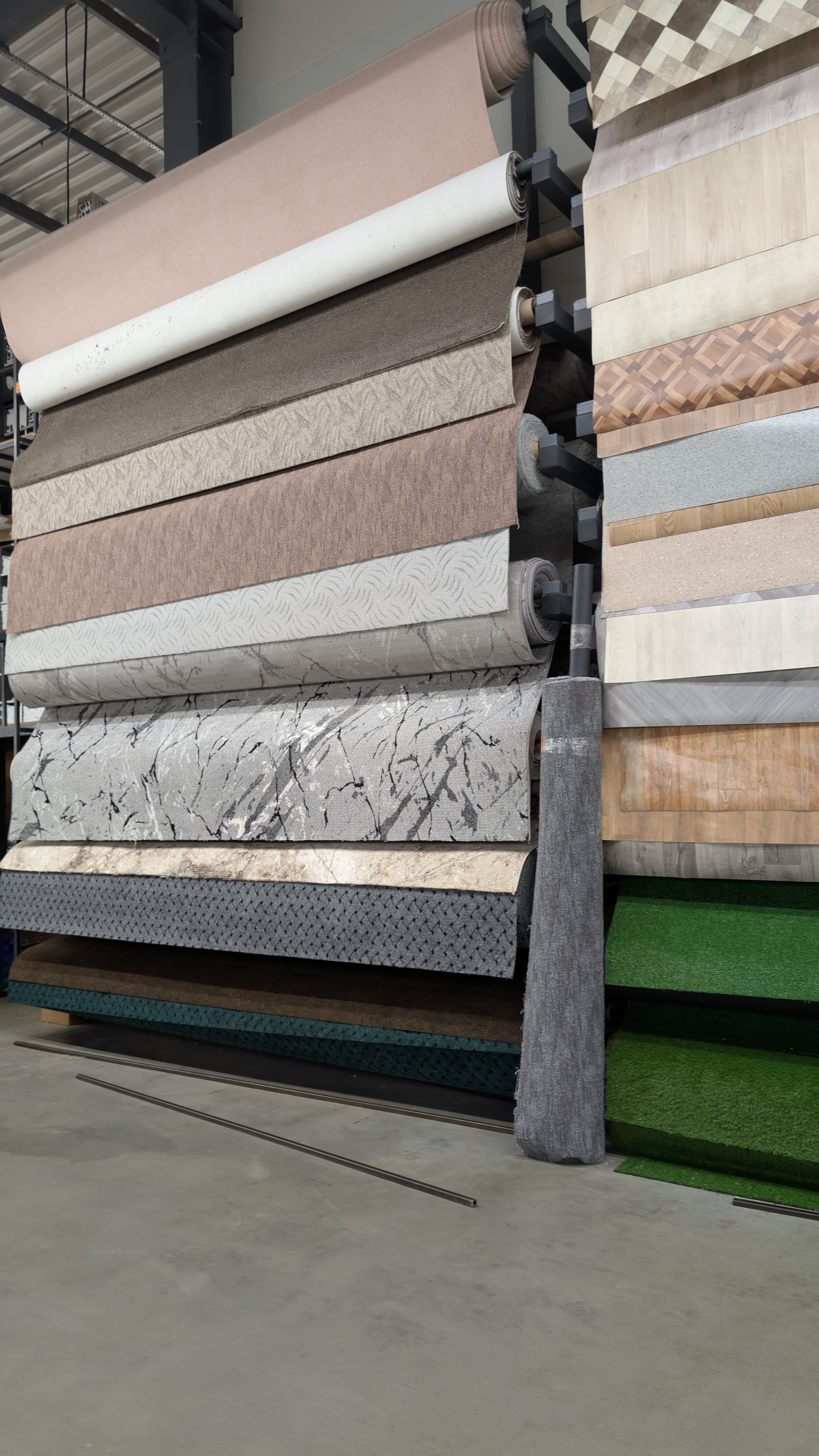 In a warehouse environment, there is a diverse collection showcasing numerous decorative flooring materials
