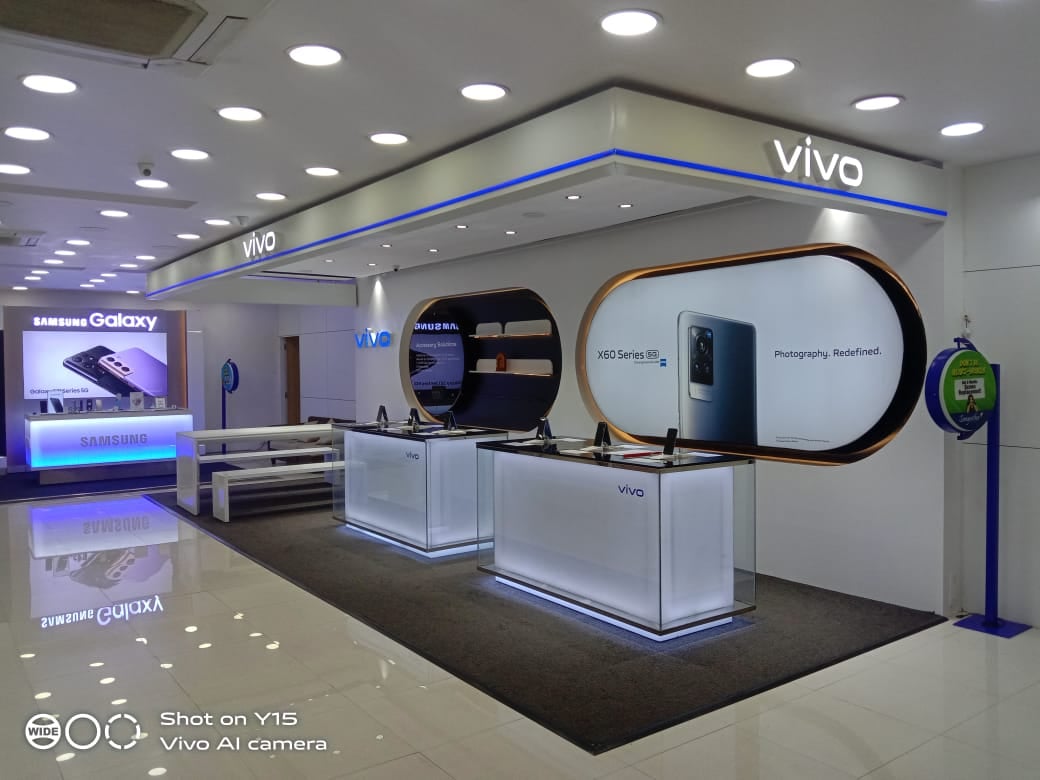A modern mobile store with Vivo and Samsung products, featuring well-lit display counters and promotional banners.