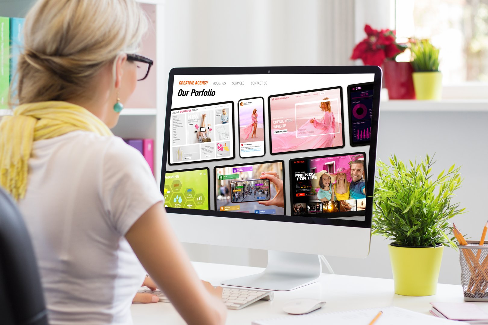Young professional working in office and viewing sample creative agency's website on computer screen