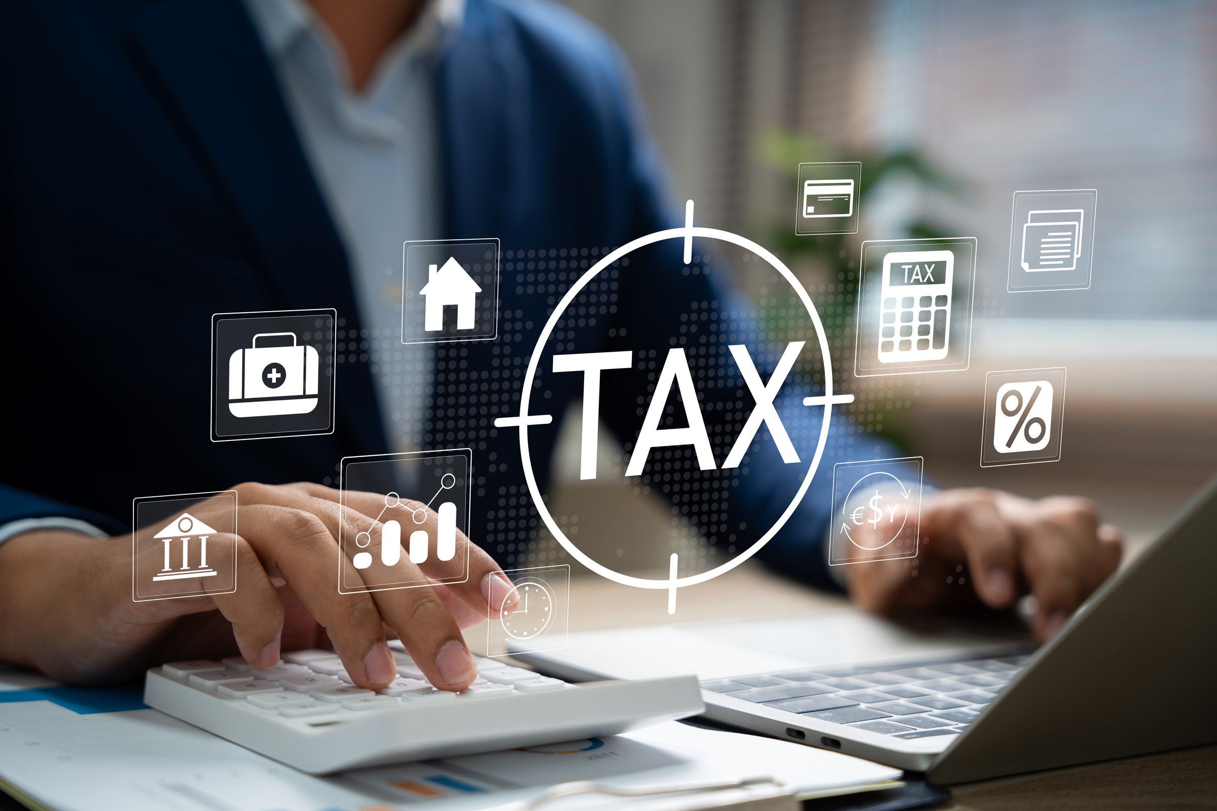 Tax and Vat concept. Government, state taxes concept. Businesman using calculator and laptop to complete Individual income tax return form online for tax payment. Data analysis, financial research.
