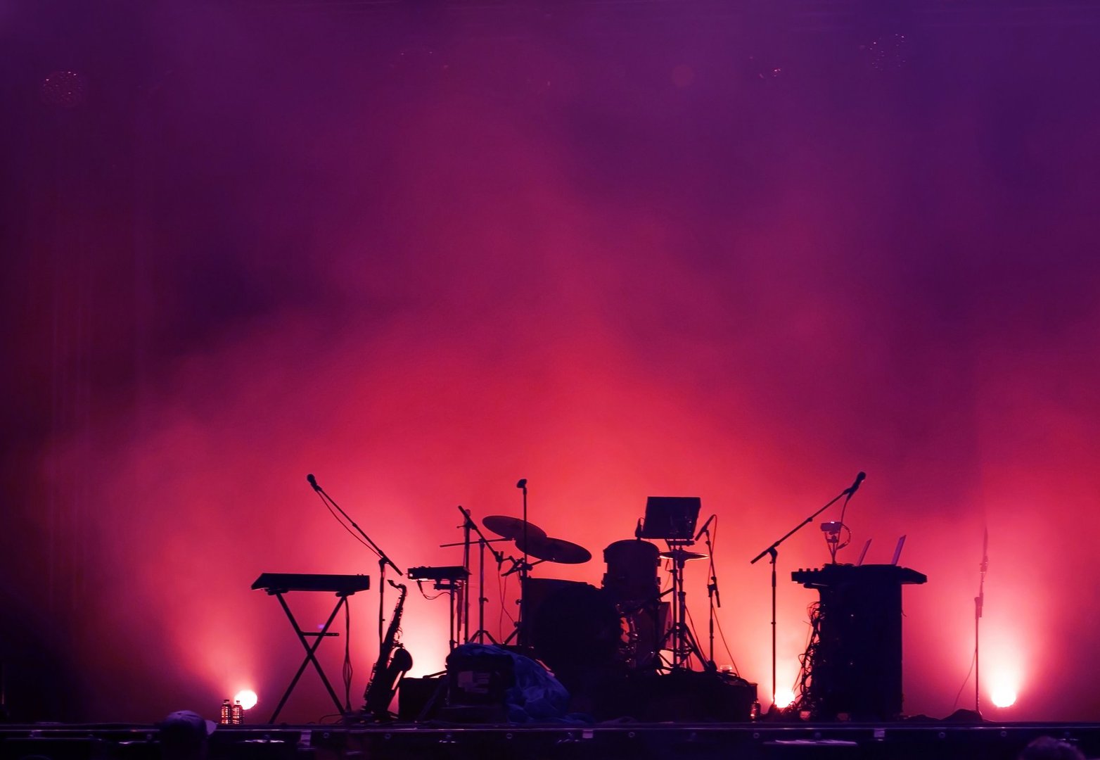 concert stage on rock festival, music instruments silhouettes, colorful background with copy space