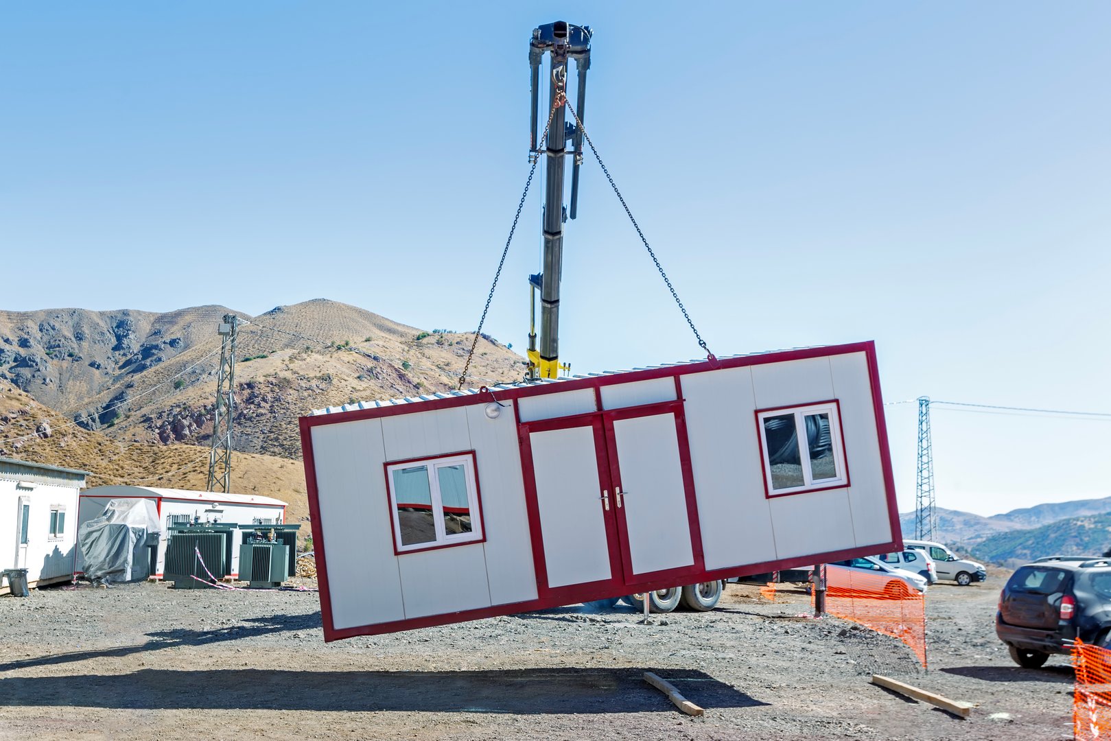 Crane lifts single storey prefabricated house. Prefabricated homes, often referred to as prefab homes or simply prefabs, are specialist dwelling types of prefabricated building, which are manufactured