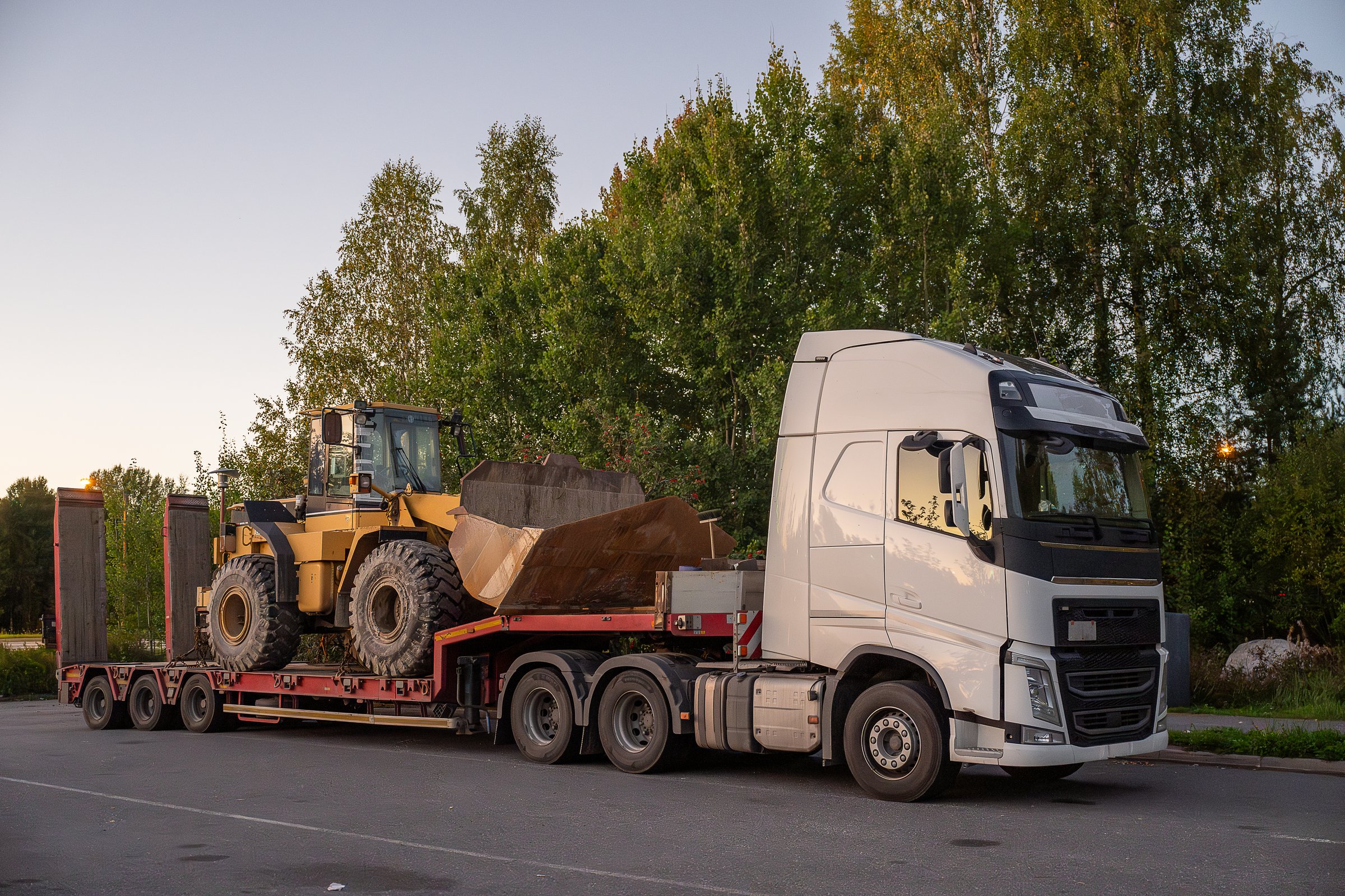 Heavy-Duty truck transporting agricultural farm tractor