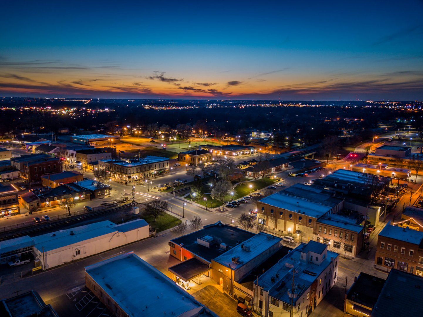Downtown Lee's Summit at dusk with illuminated buildings and scenic cityscape