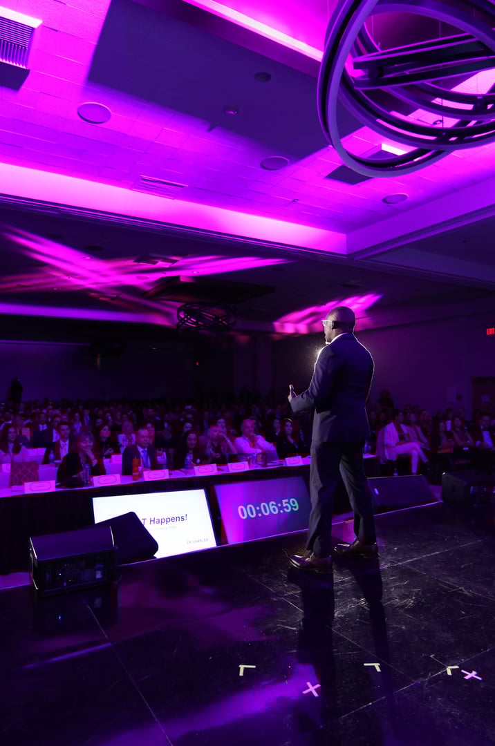 CK Charles speaking on stage