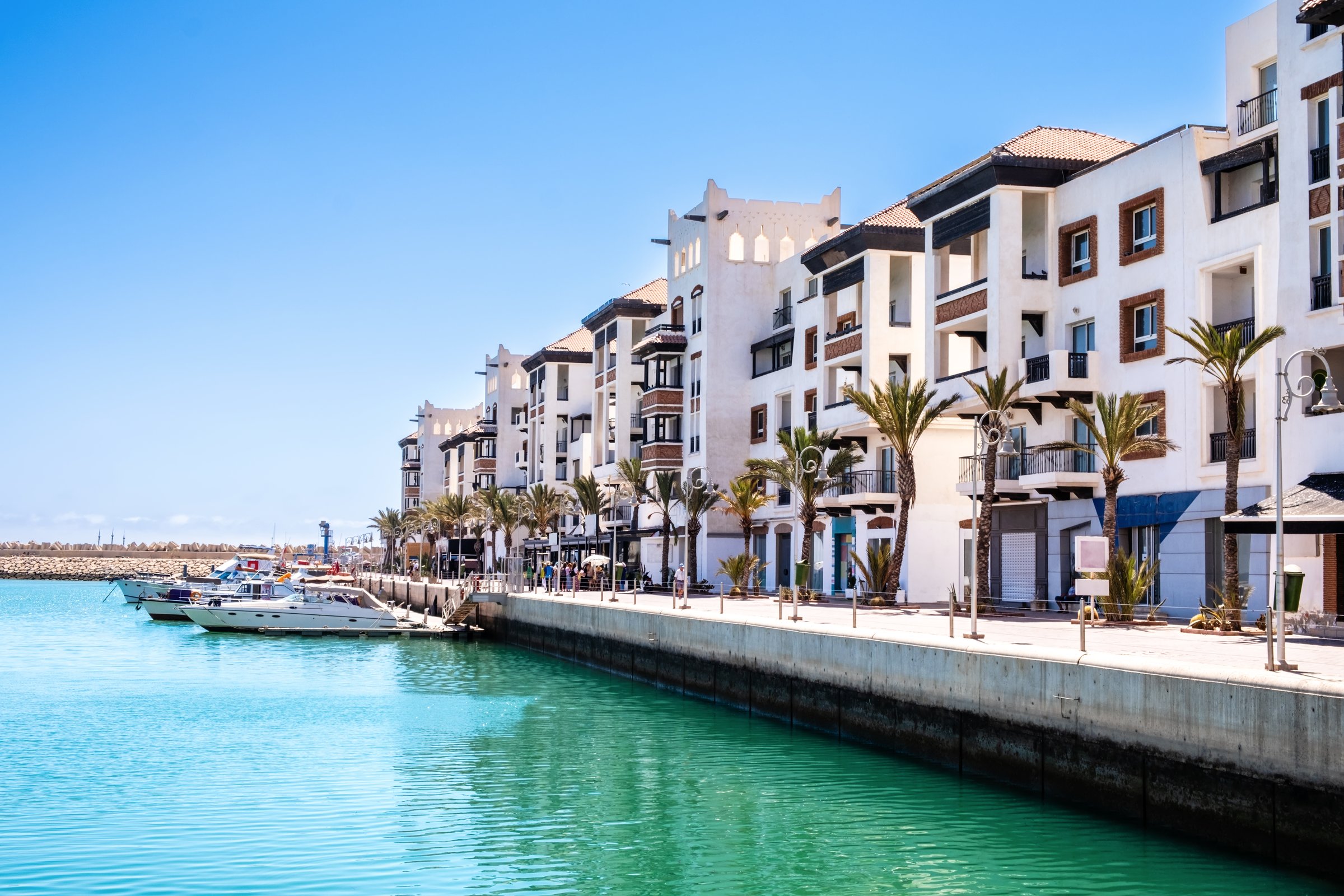 Agadir Marina with luxury apartments, boats in harbor, shops and restaurants. Popular tourist destination in Moroccan seaside resort on shore of Atlantic ocean in Africa.