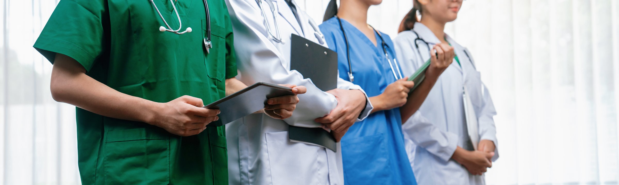 Confident and professional team of medical staff stand in line together as healthcare service and doctor leadership at hospital background. Teamwork lead to successful medical treatment.Panorama Rigid