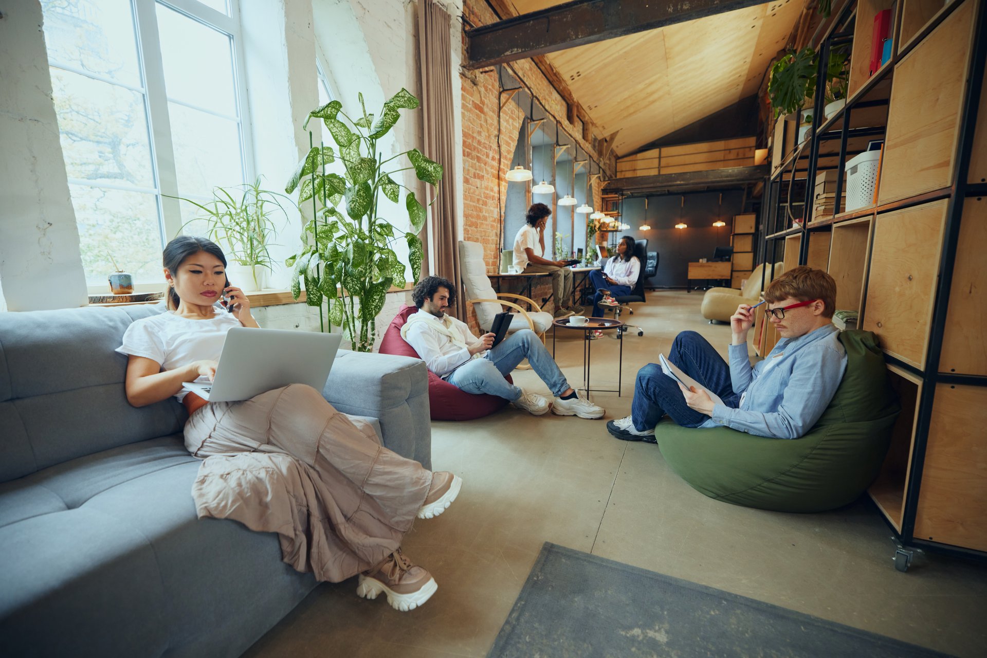 Creative business hub. Young multi ethnic people gathering in modern office for work and study, finishing own tasks in cozy but professional atmosphere. Business and education, co-working space
