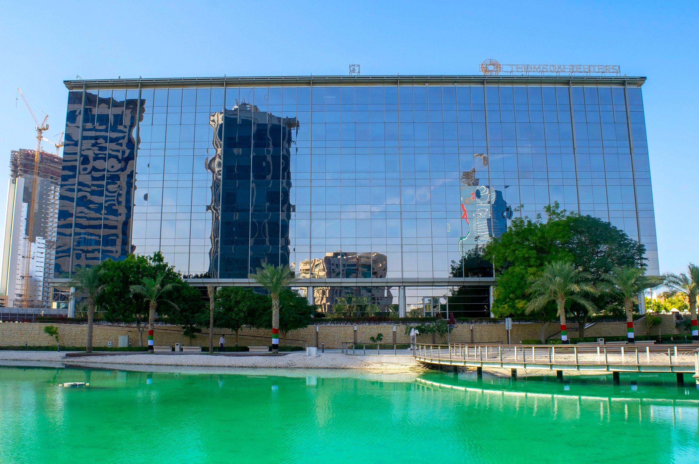 Dubai - UAE - December 18, 2020: Canadian Thomson Reuters Corp. buildings in Dubai. Worldwide famous media company headquarter exterior in the park.