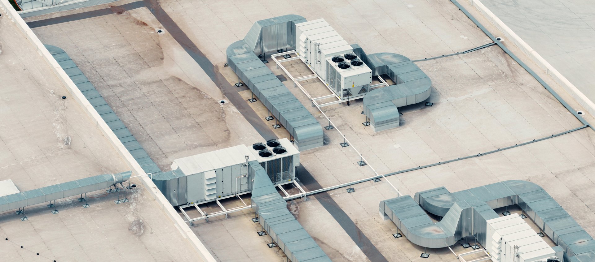 Rooftop hvac units are maintaining a comfortable temperature inside a building with pvc membrane roof