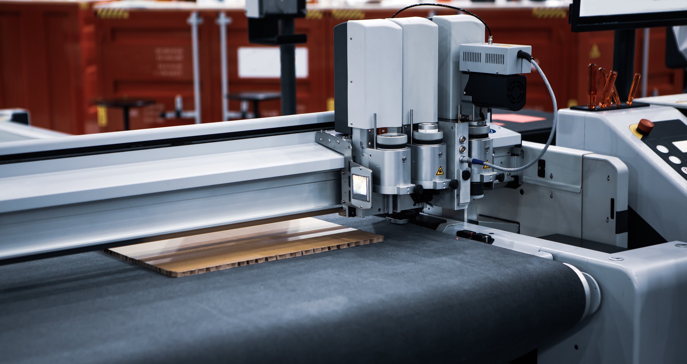 Digital laser die cut machine cutting corrugated cardboard. Industrial manufacture.