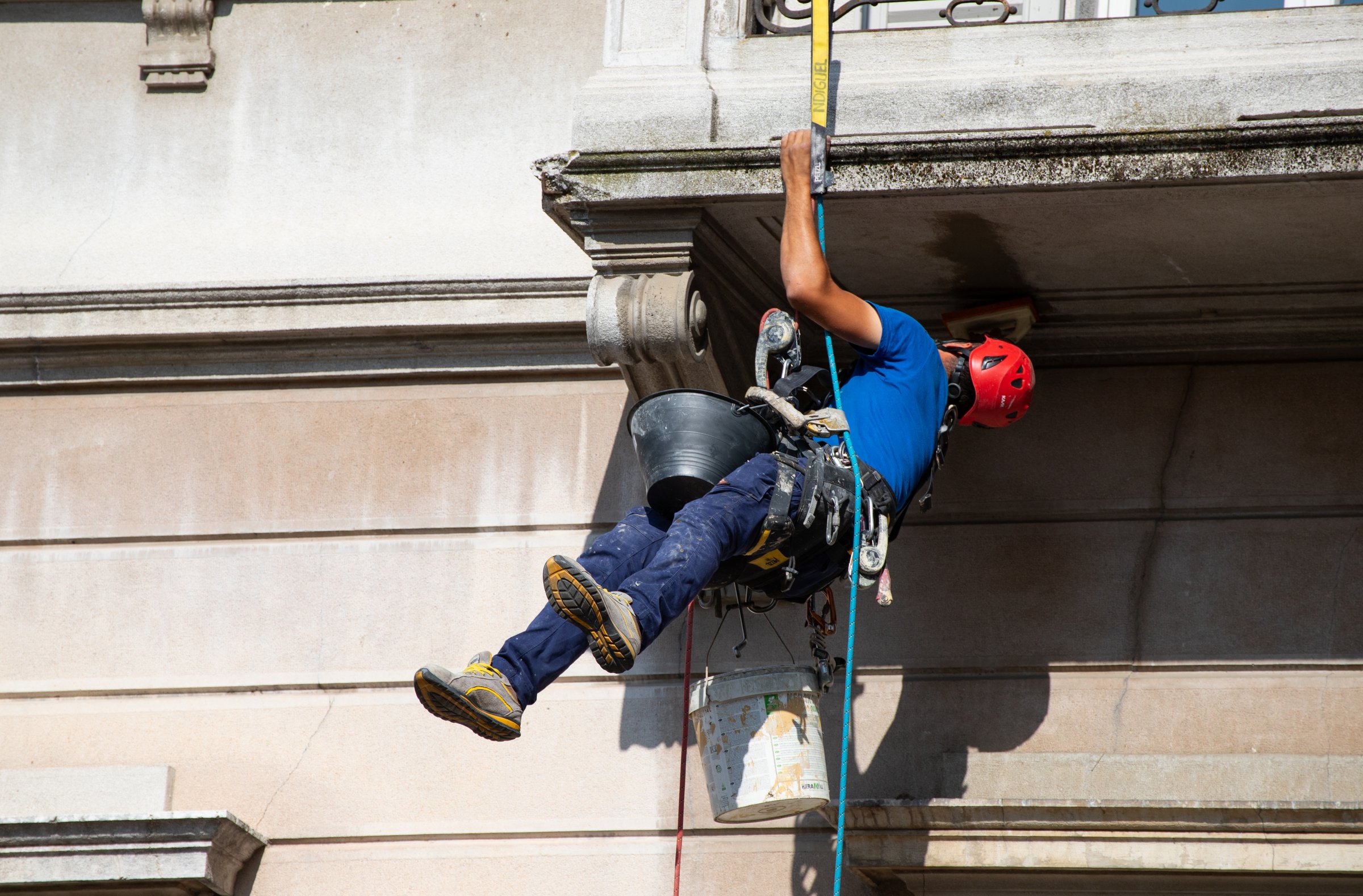Parma, Italy, June 7, 2025: Professional rope access services for listed buildings: safe exterior repair, cleaning, and preservation without scaffolding or heavy equipment.