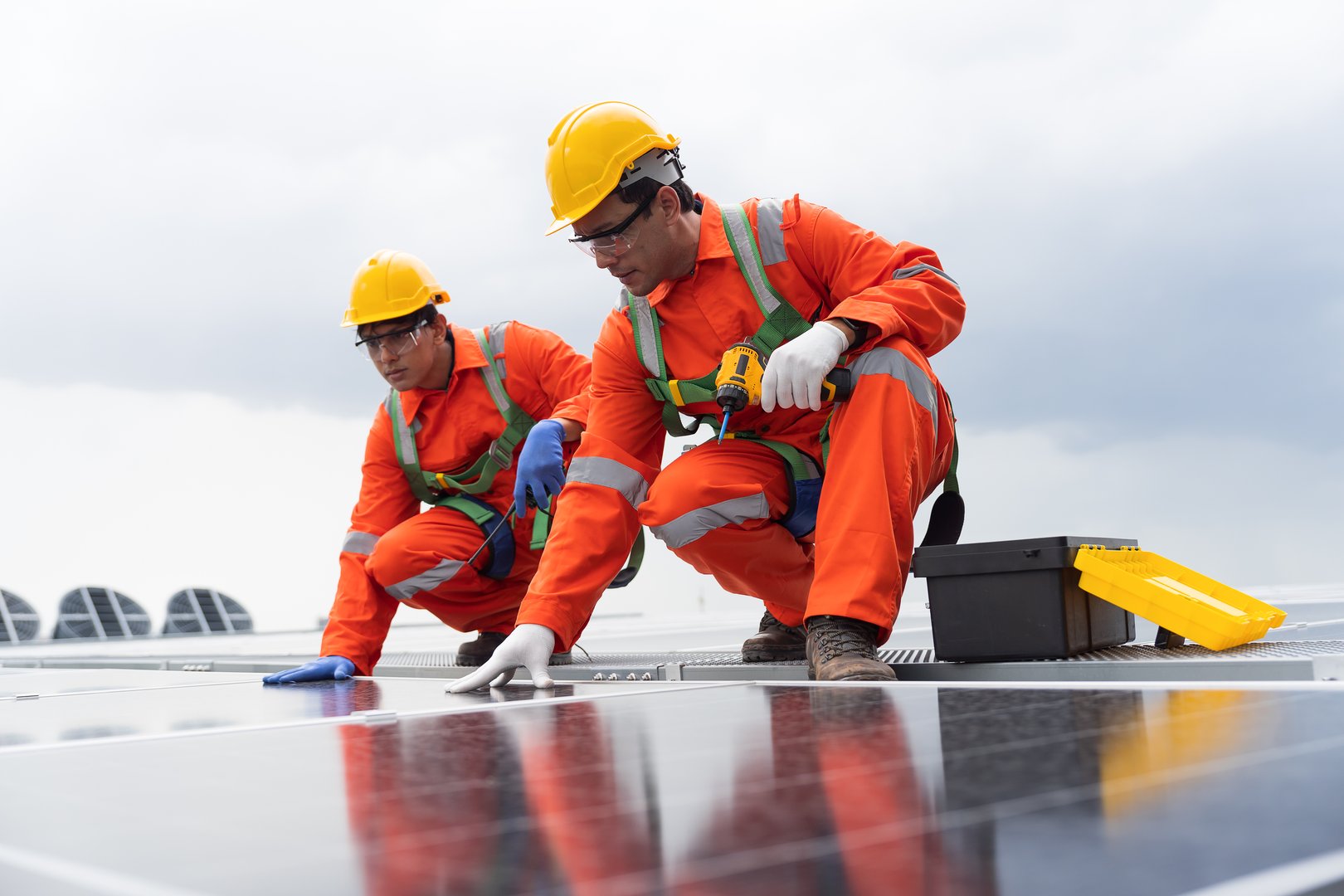 Solar panel manufacturers, Rooftop solar power, Solar rooftop. Team of engineers or technicians with safety uniform maintaining and repairing solar power systems rooftop of building