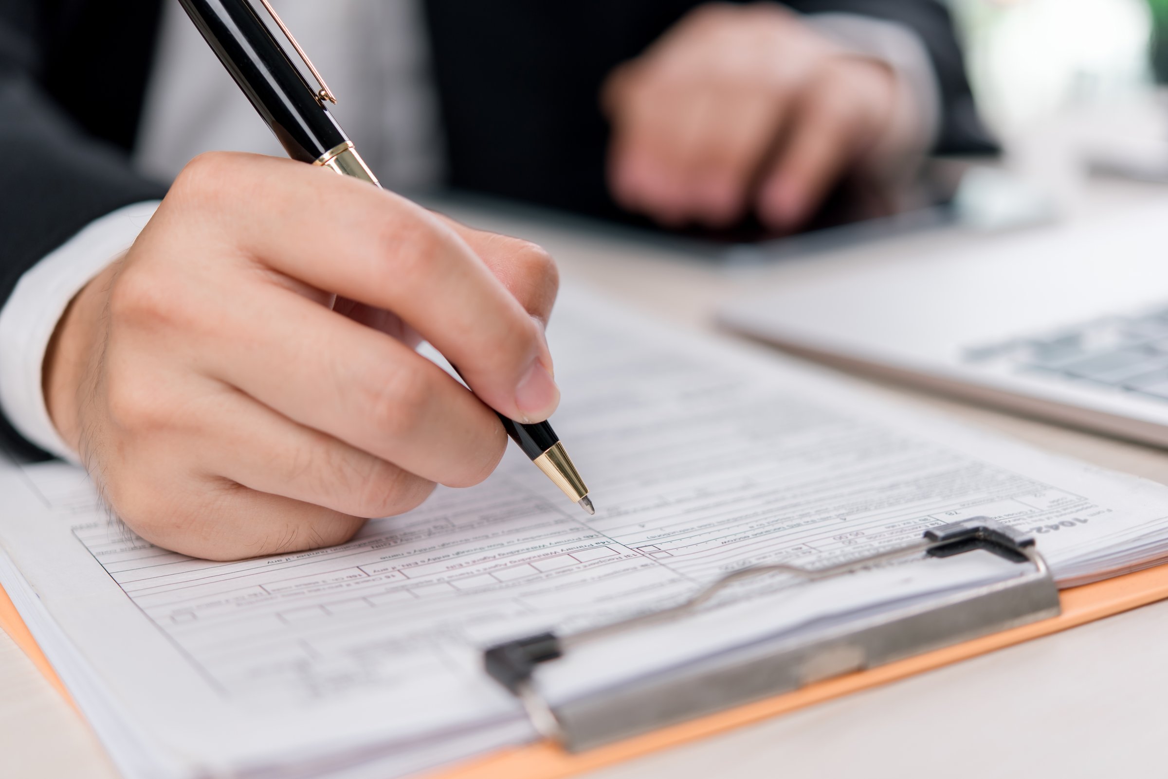 Business and financial paperwork verification featuring a close-up of hands working on a contract. Ideal for corporate, investment, and legal consulting.