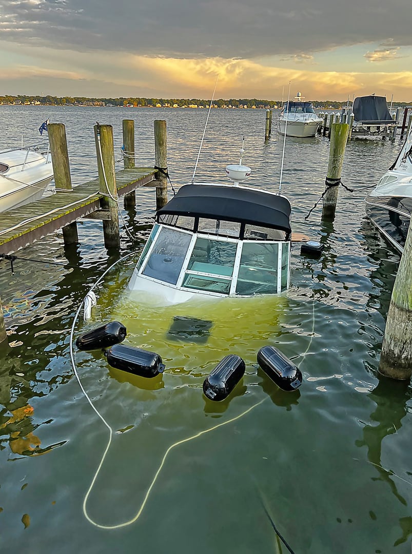 Sinking power boat in boat slip