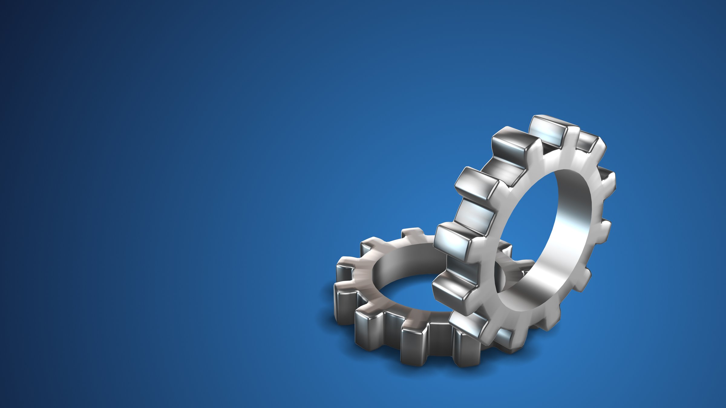 This stock image Close-up view of mechanical gears in motion against a vibrant blue background