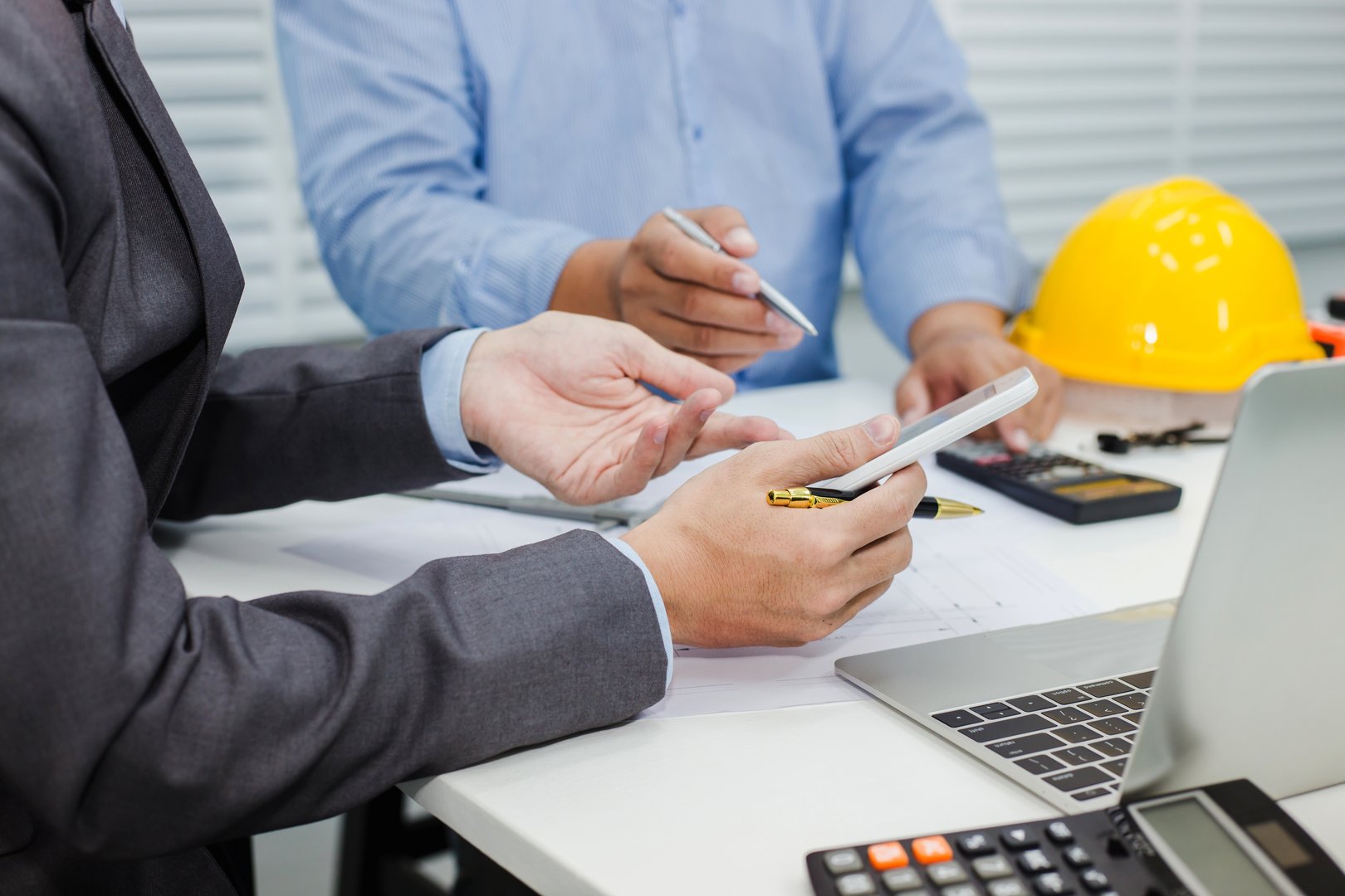 Architects and businessman analyze and plan projects together at the meeting.
