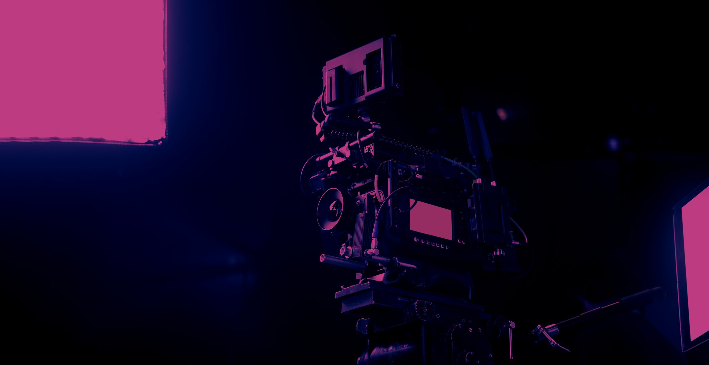 Film or video production setup with high end professional cinema cameras lighting camera rig and crew members working on set