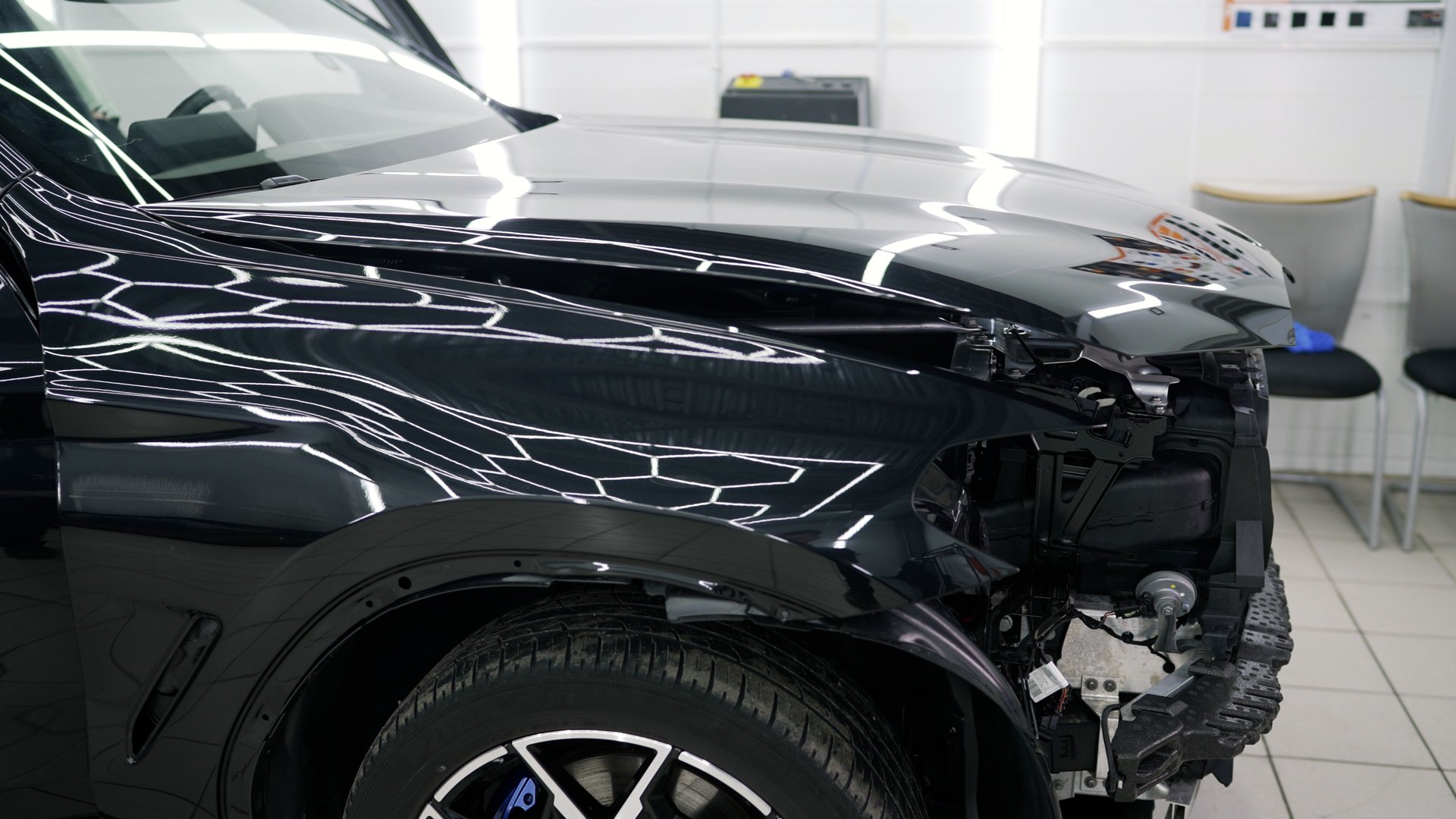 Damaged car being restored by mechanics