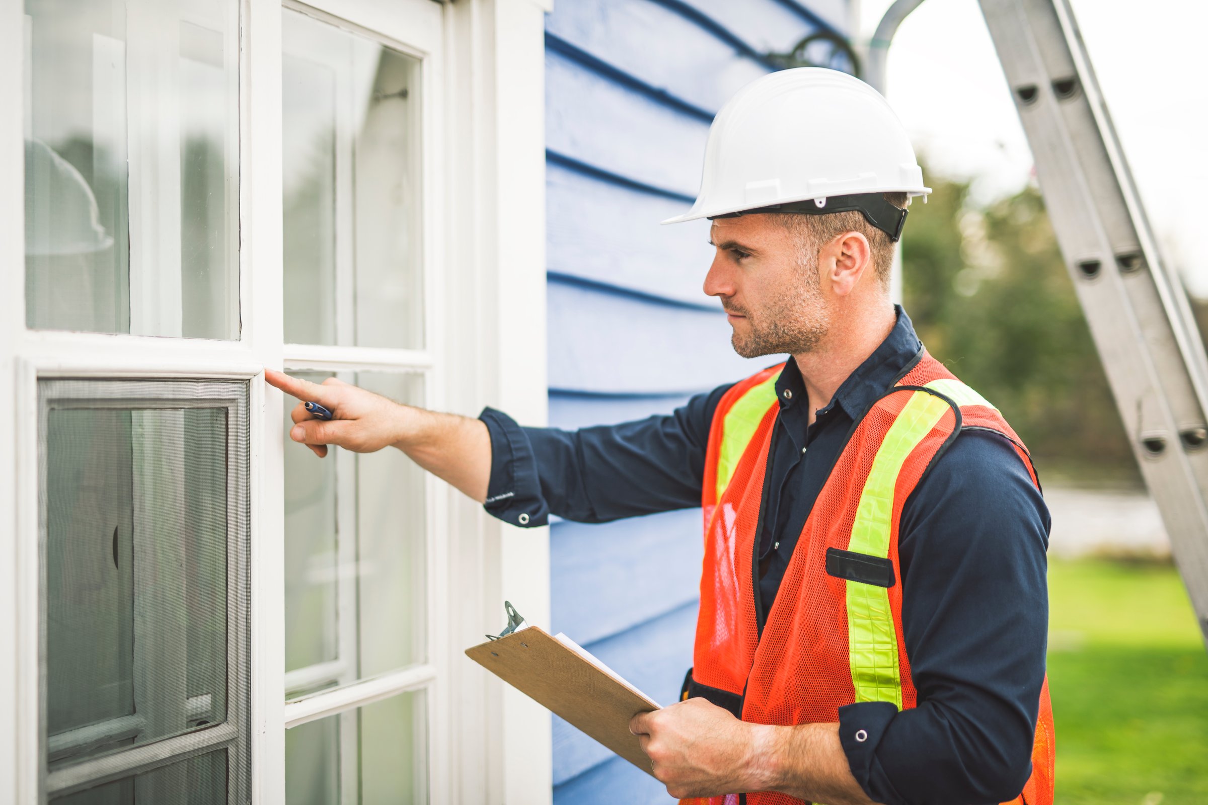 A man inspecting house window outside on day light