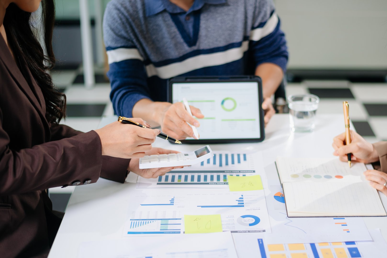 Businessman and team analyzing financial statement Finance task. with smart phone and laptop and tablet. Wealth management concept