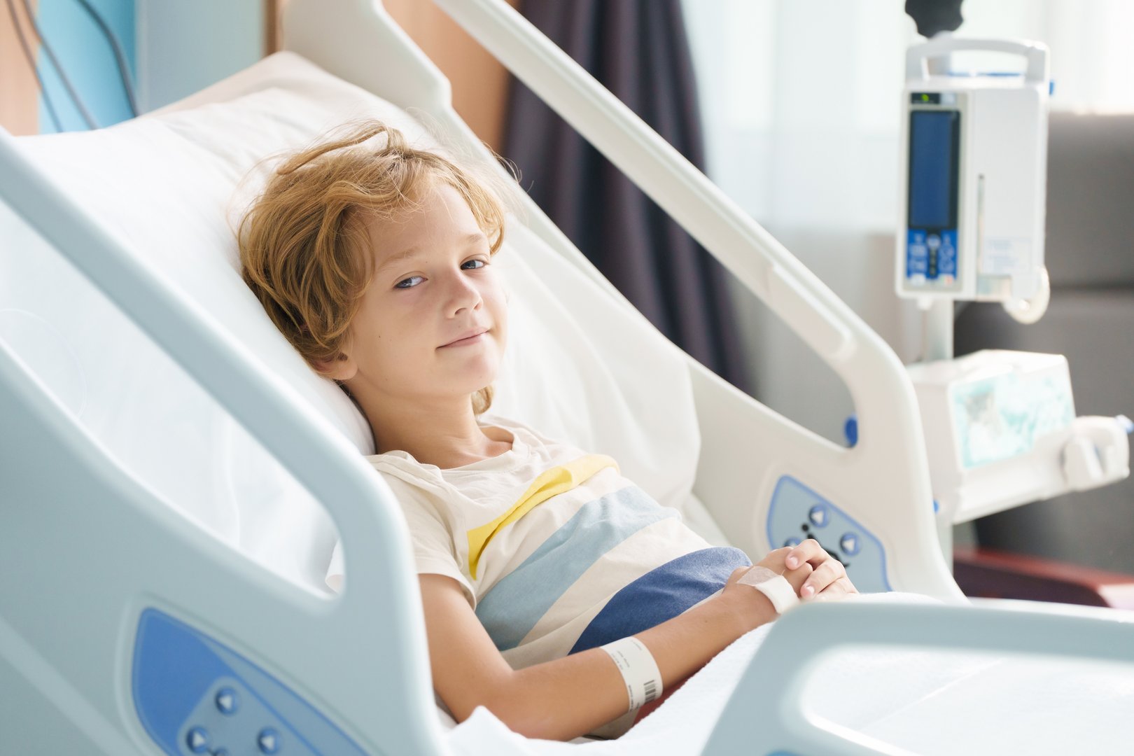 Sick child in hospital room with pediatrician doctor examining patient