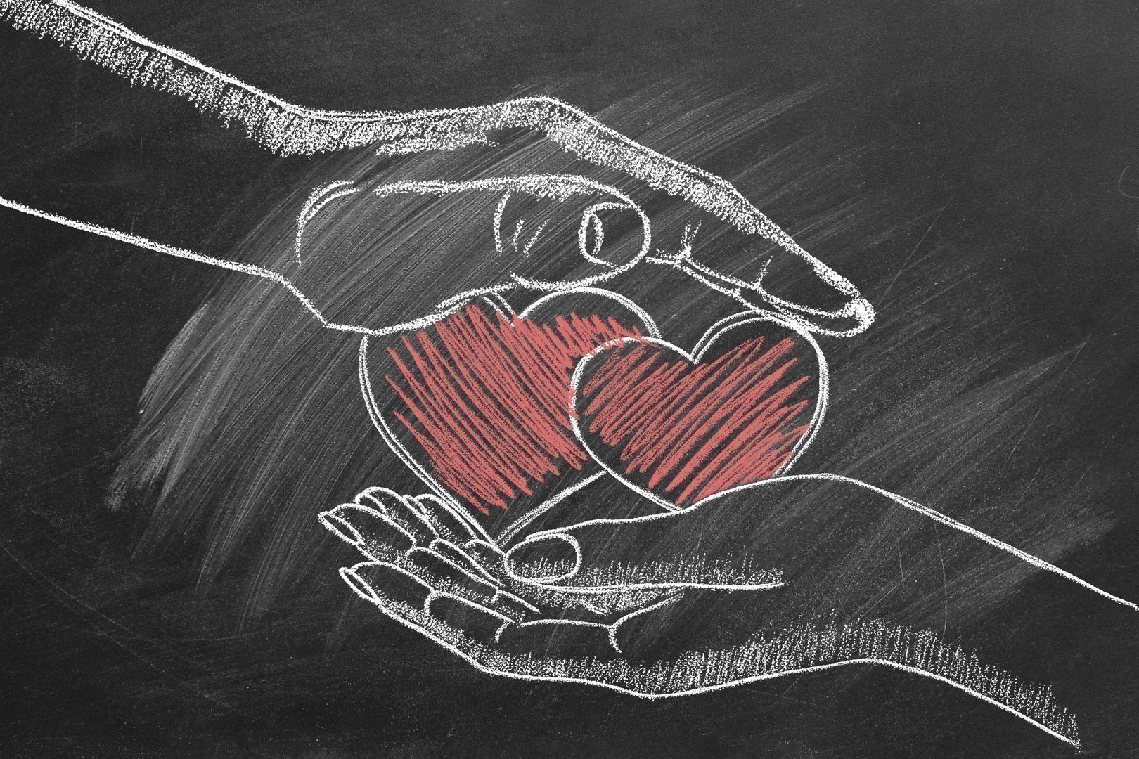 Male and female hands with two hearts. Chalk drawn illustration.