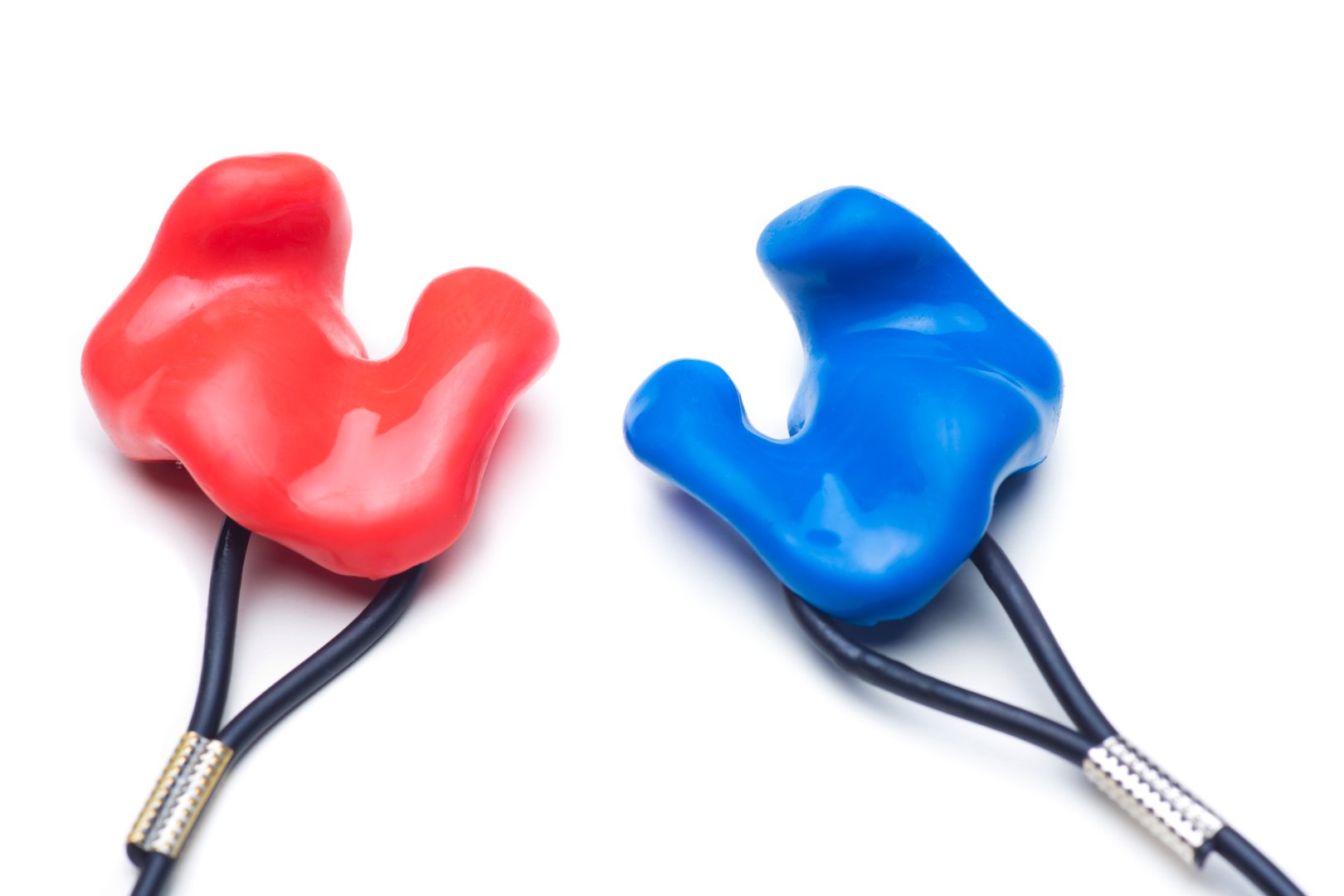 Close-up of customized earplugs of silicone for hearing protection or swimming in red and blue isolated on white background