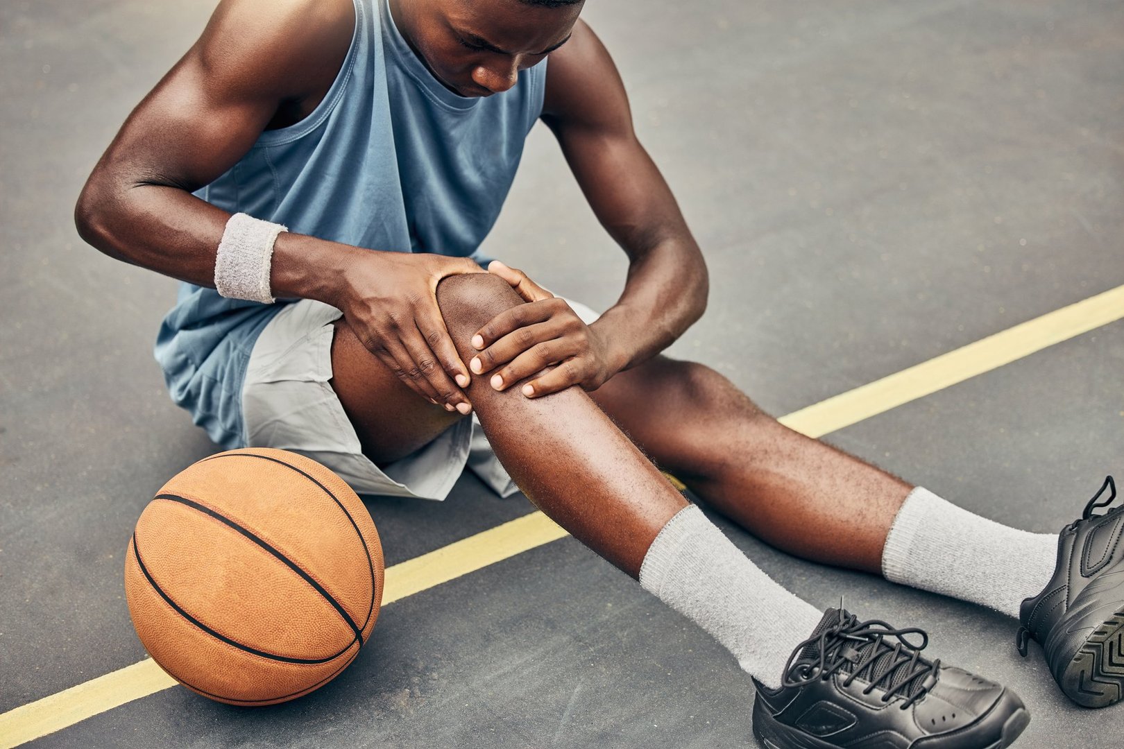 Fitness, basketball knee injury or pain while on basketball court holding leg in exercise