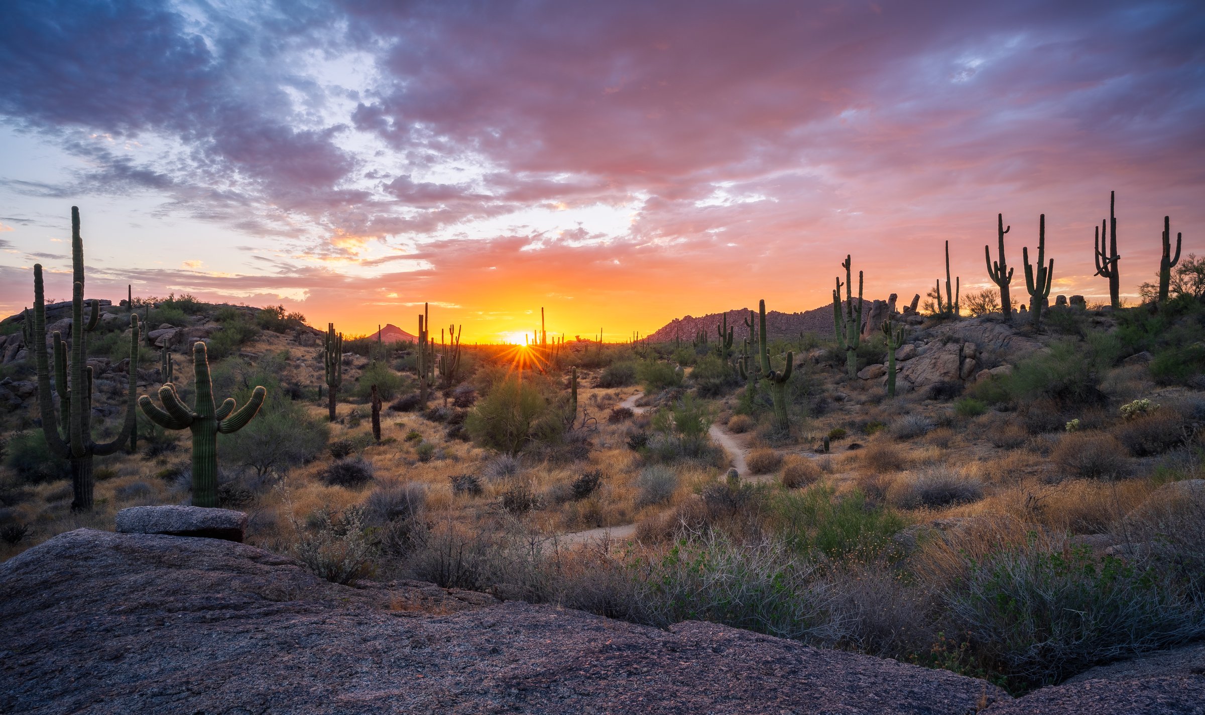 The fiery hues of a brilliant sunset paint the sky in the Sonoran Desert Landscape at Granite Mountain in Scottsdale, AZ
