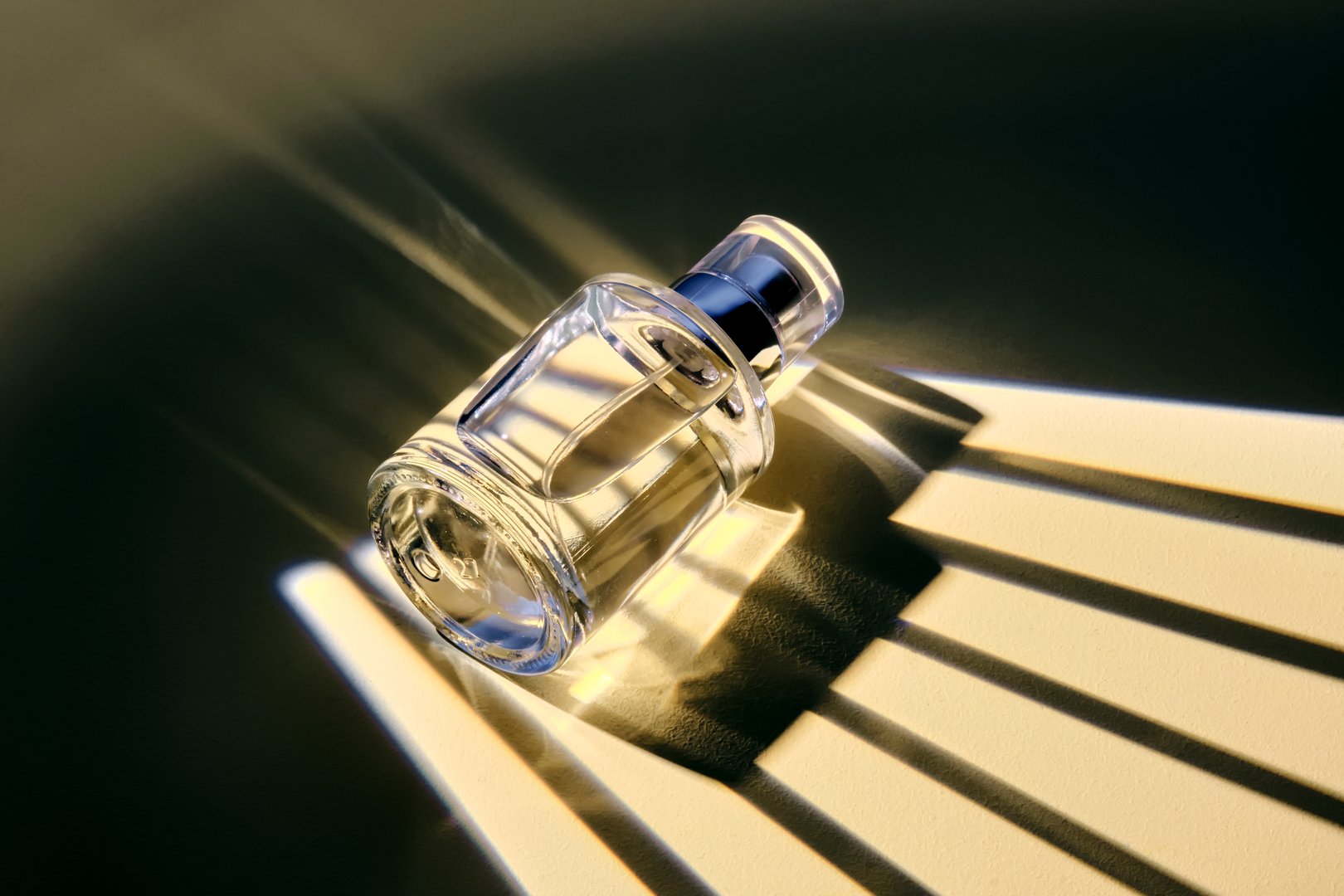 A bottle of perfume spray in an interesting light with stripes of shadows