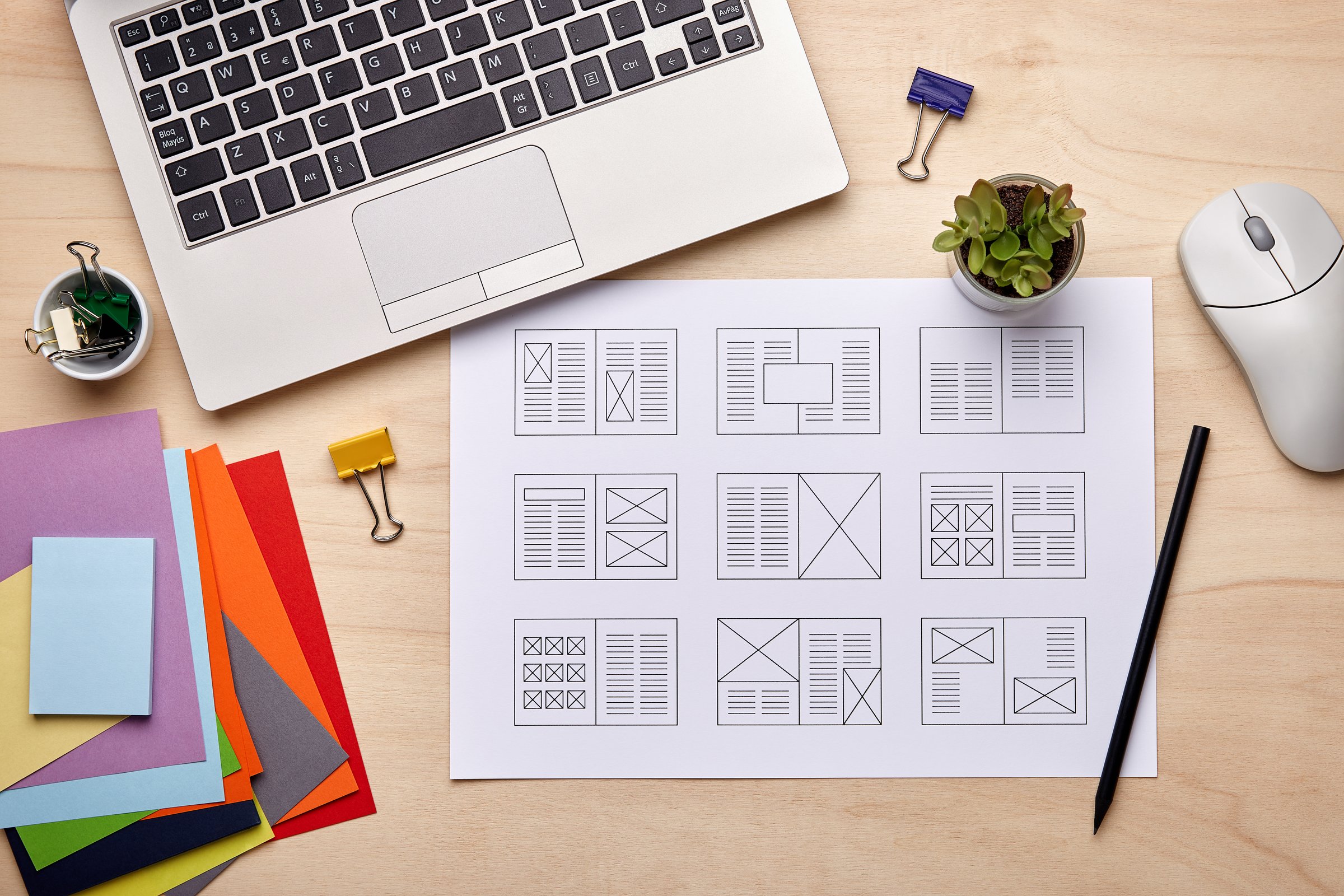 Editorial design. Graphic designer desk with magazine layout designs. Flat lay