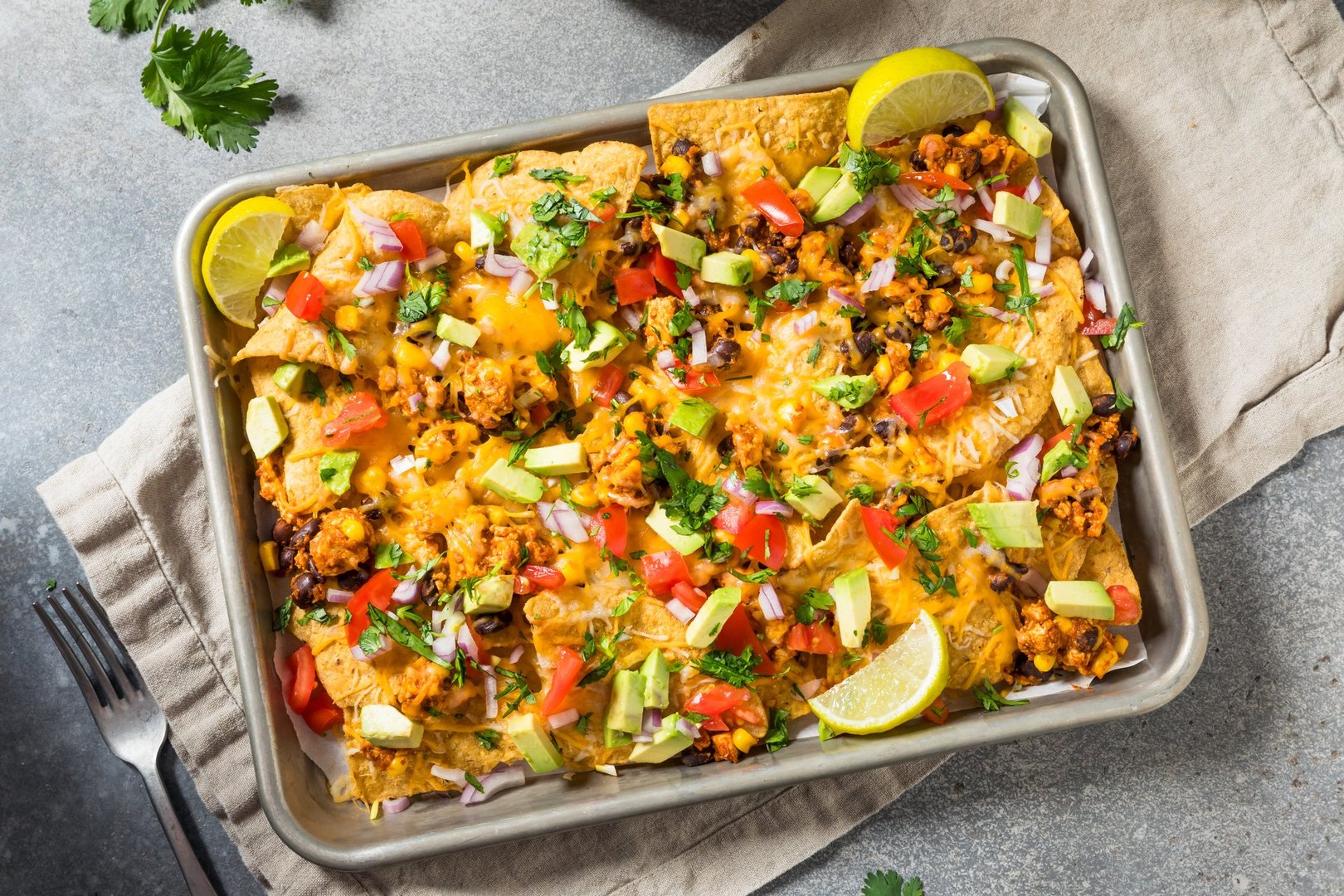 Homemade Vegan Loaded Sheet Pan Nachos with Tomato Cilantro and Lime