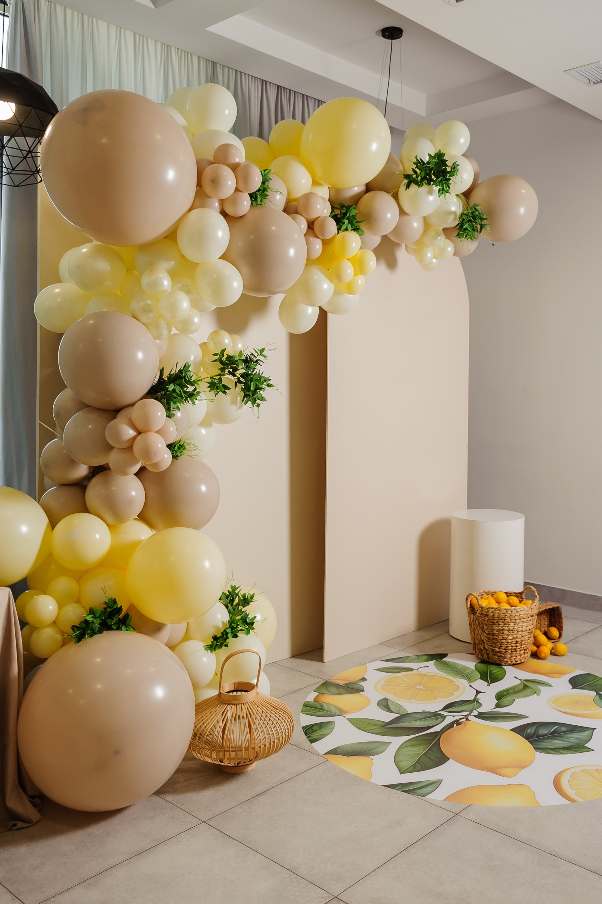 Photo zone with arch, balloons, flowers, lemons on party