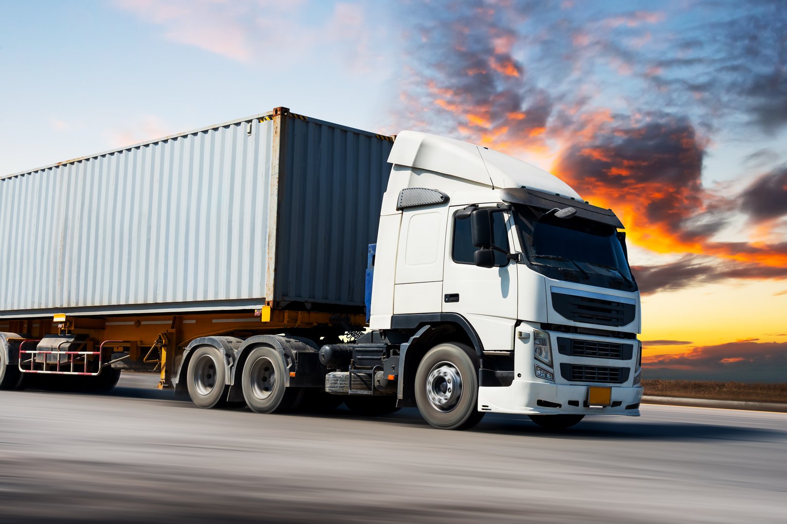 Semi Trailer Trucks Driving on The Road at Sunset Sky. Shipping Cargo Container. Economy Business Transport on Road. Shipping Import- Export. Trucking. Freight Logistics Truck Transportation.