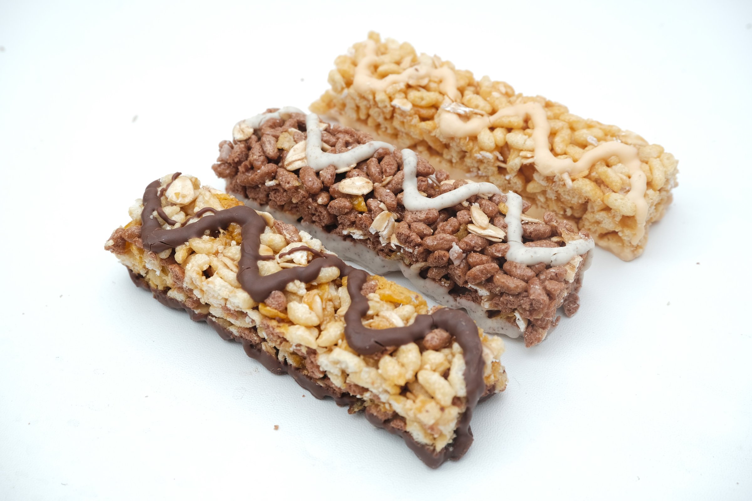 Sugarfree.space energy bars - Top view on three granola bars on white background