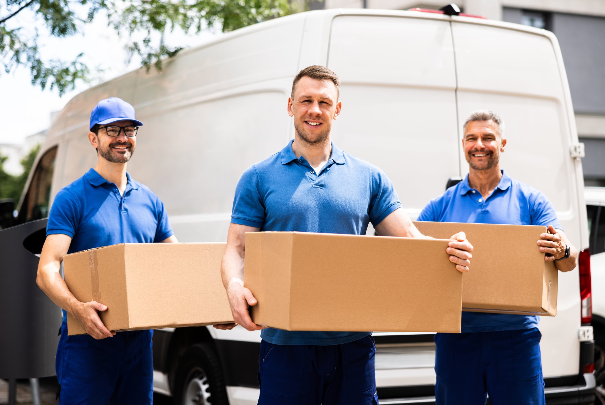 Professional Movers Loading a Van with Boxes for a House Move, Efficient Truck Driver Executing Relocation Services With Team.