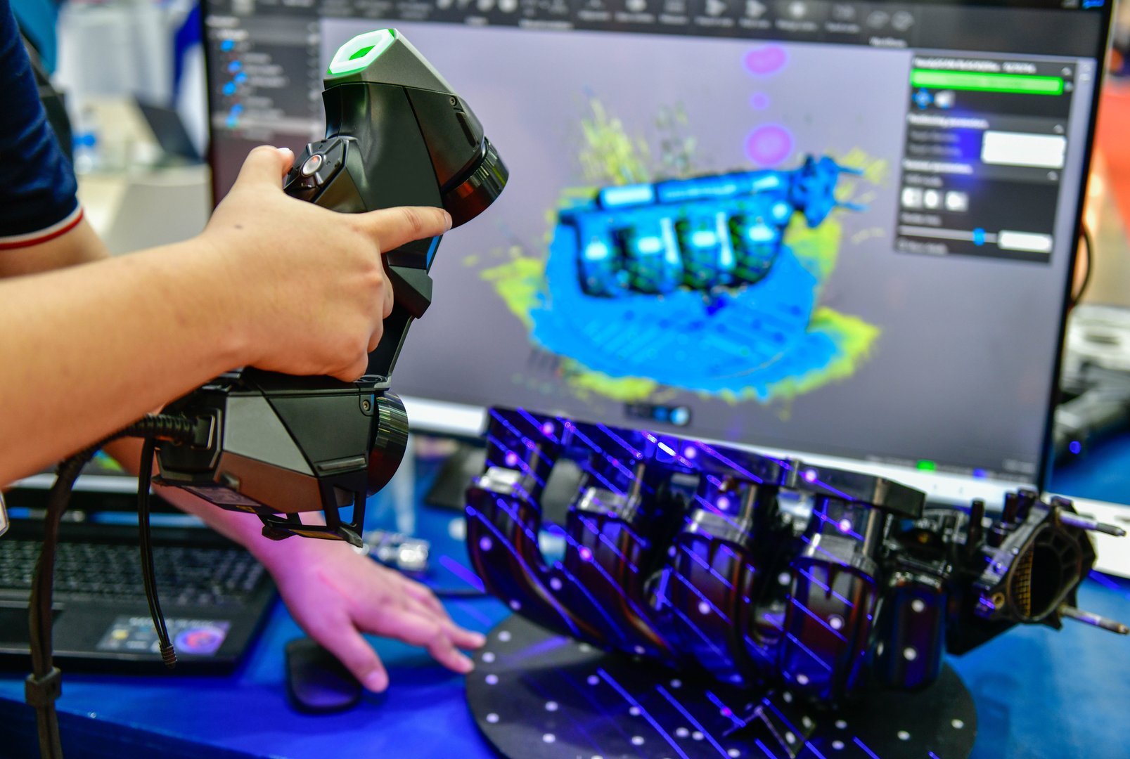 Portable 3D car-shaped handheld scanner is scanning to measure size and texture for future product development production in the automotive industry