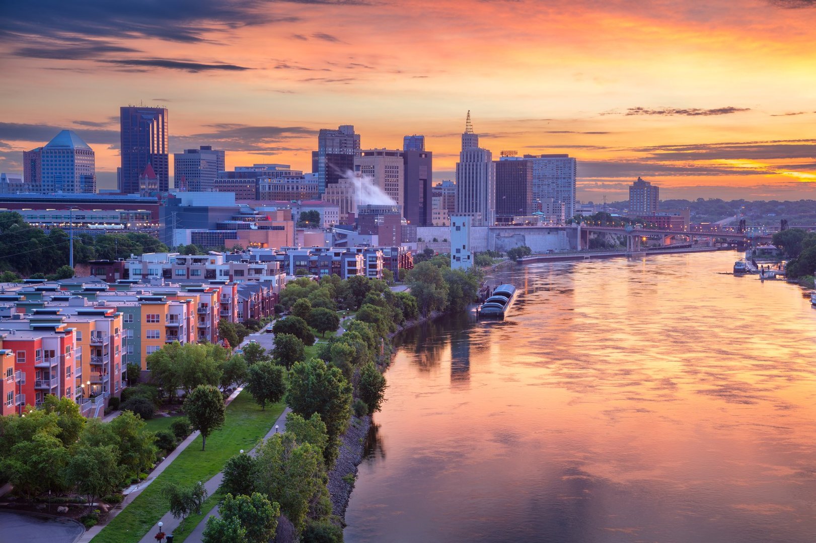 Aerial cityscape image of downtown St. Paul, Minnesota with river reflection