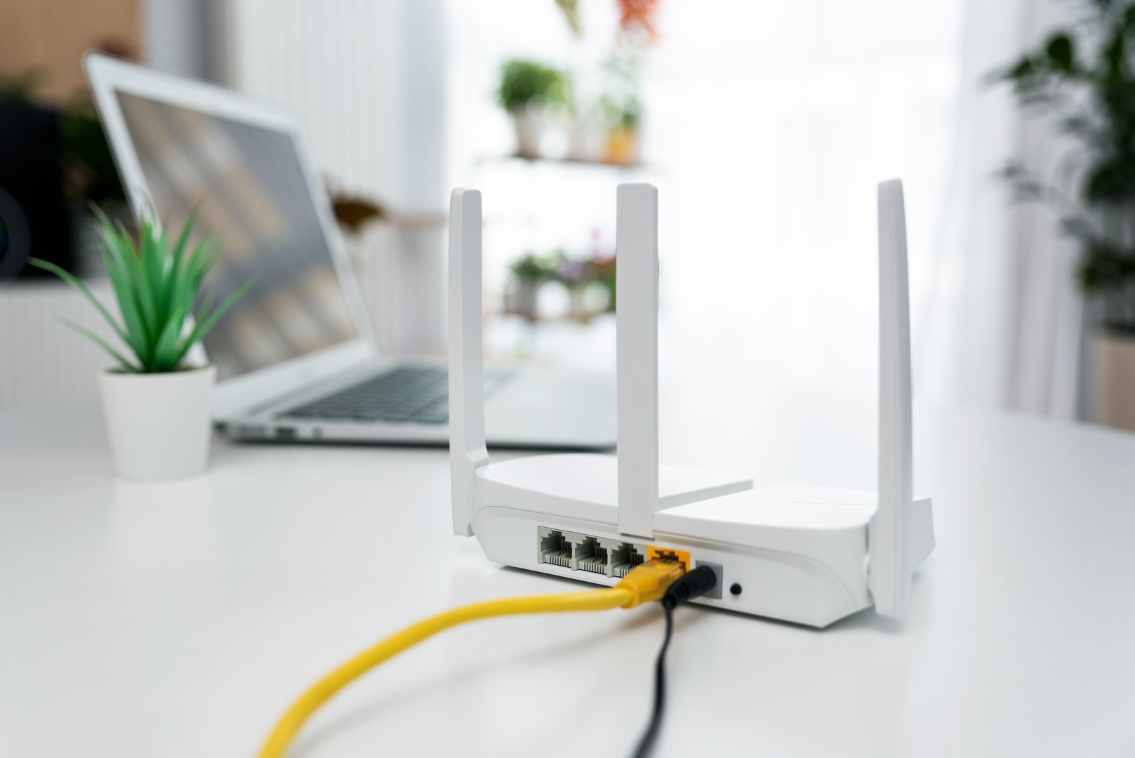 Modern wi-fi router on light table in living room