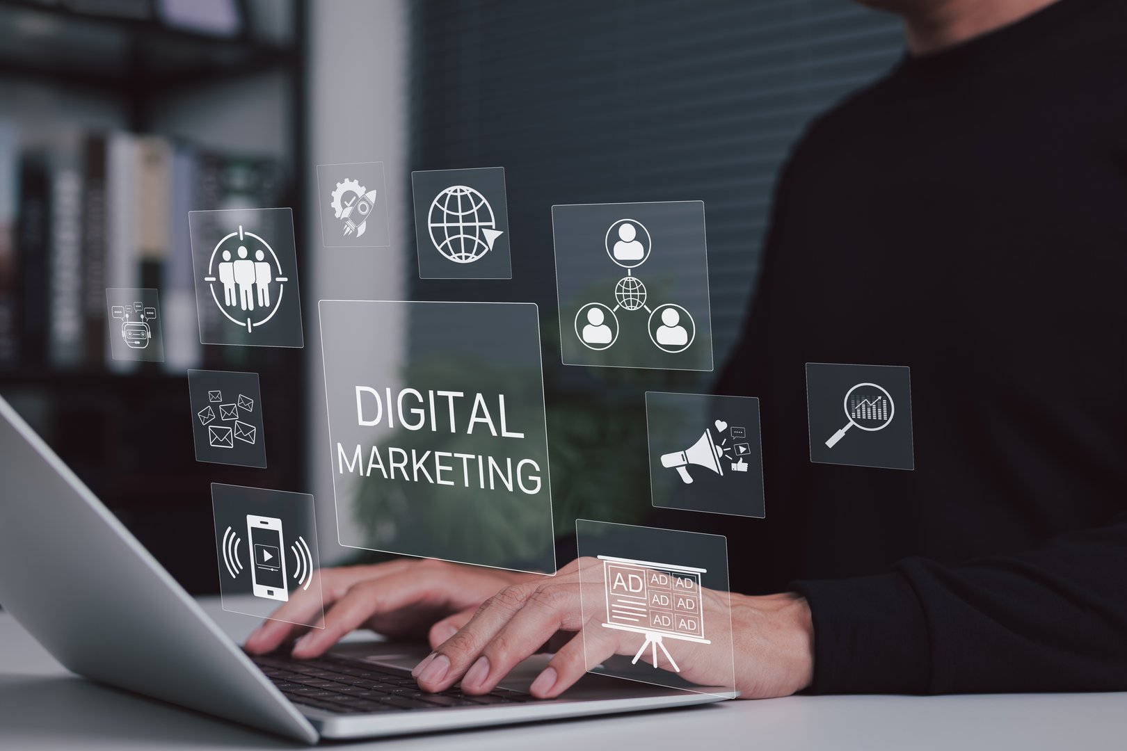 Digital marketing and online advertising concept. Person working on laptop with icons for marketing, social media, online advertising, content strategy, user targeting, and performance analytics.