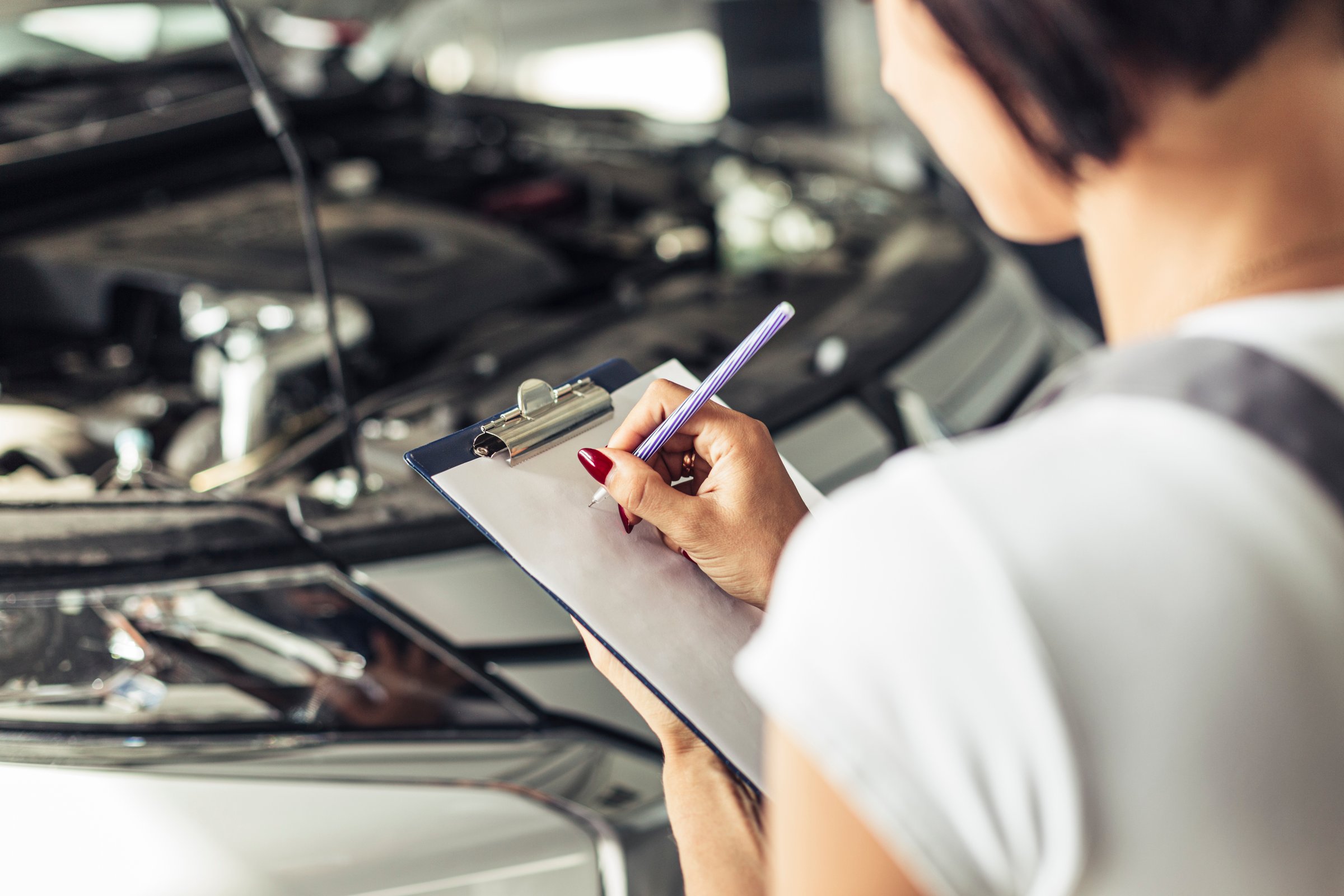 High angle woman filling car service form