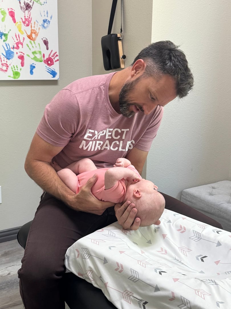 Dr. Harrison providing gentle chiropractic care