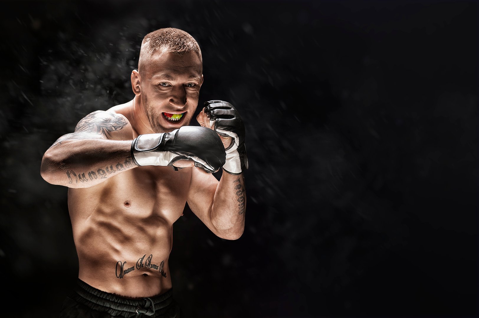 Mixed martial artist posing on a black background. Concept of mma, ufc, thai boxing, classic boxing. Mixed media