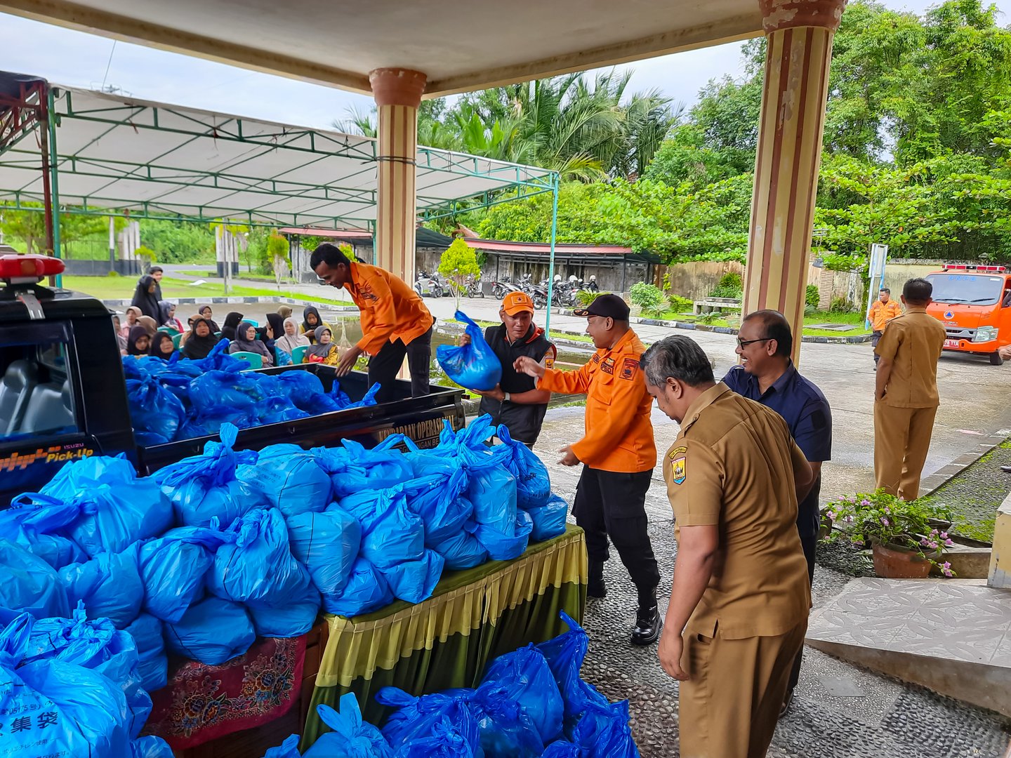 Humanitarian aid workers distributing food aid to residents affected by crisis