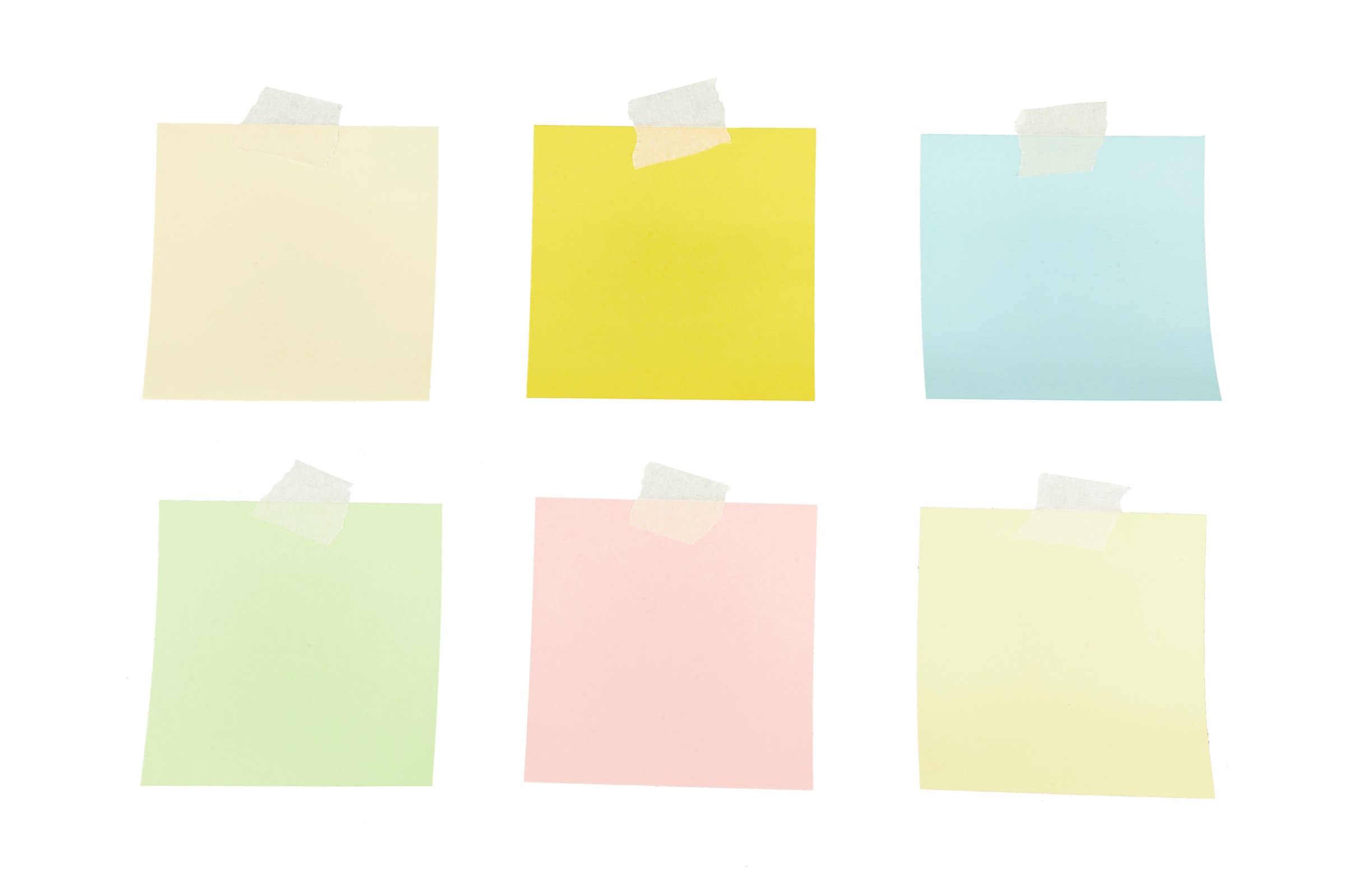 different colored sticky notes taped against wall isolated