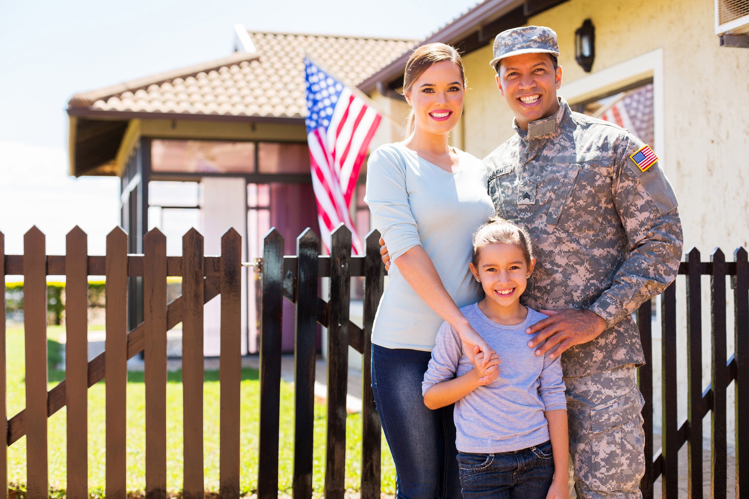 happy american soldier reunited with family outside their home