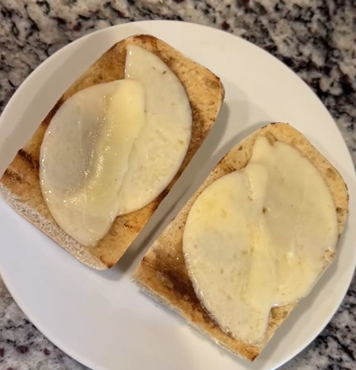 Toasted rolls with melted provolone cheese