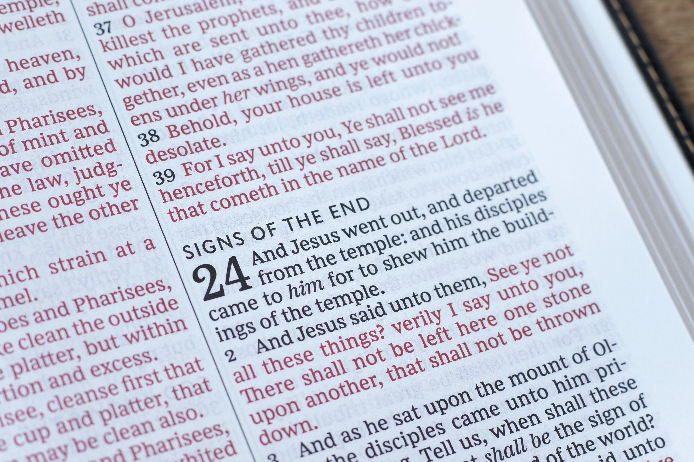 Signs of the end text in open holy bible book. Close-up. Prophecy and revelation, Christian biblical concept.