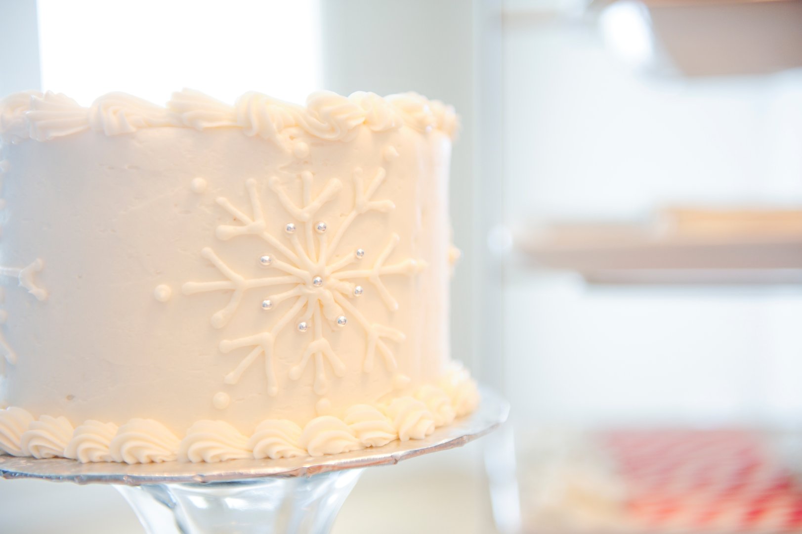 White cake with frosted snowflakes. Perfect for a winter wedding, christening, or any Christmas meal.